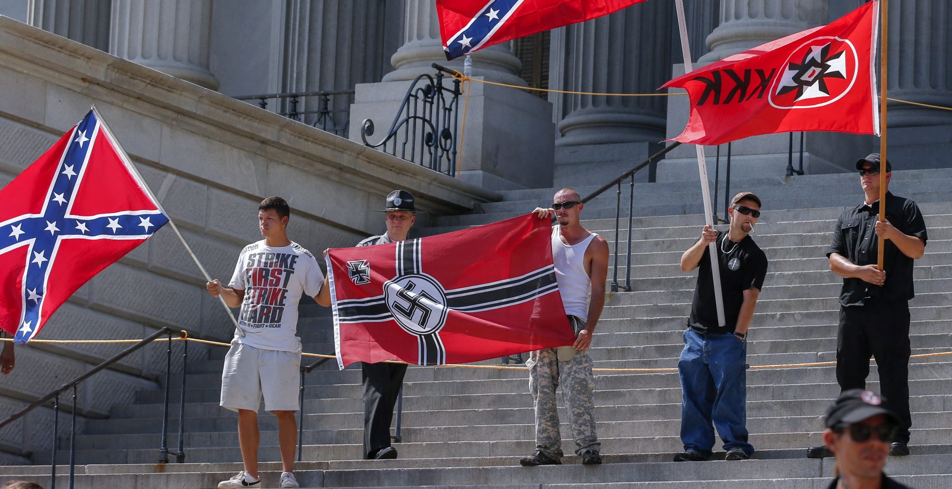 epa04852673 Members of white supremacists groups rally on the steps of the South Carolina Statehouse during New Black Panther Party and the Loyal White Knights of the Ku Klux Klan rallies on the grounds of the South Carolina Capitol in Columbia, South Carolina, USA, 18 July 2015.  EPA/ERIK S. LESSER