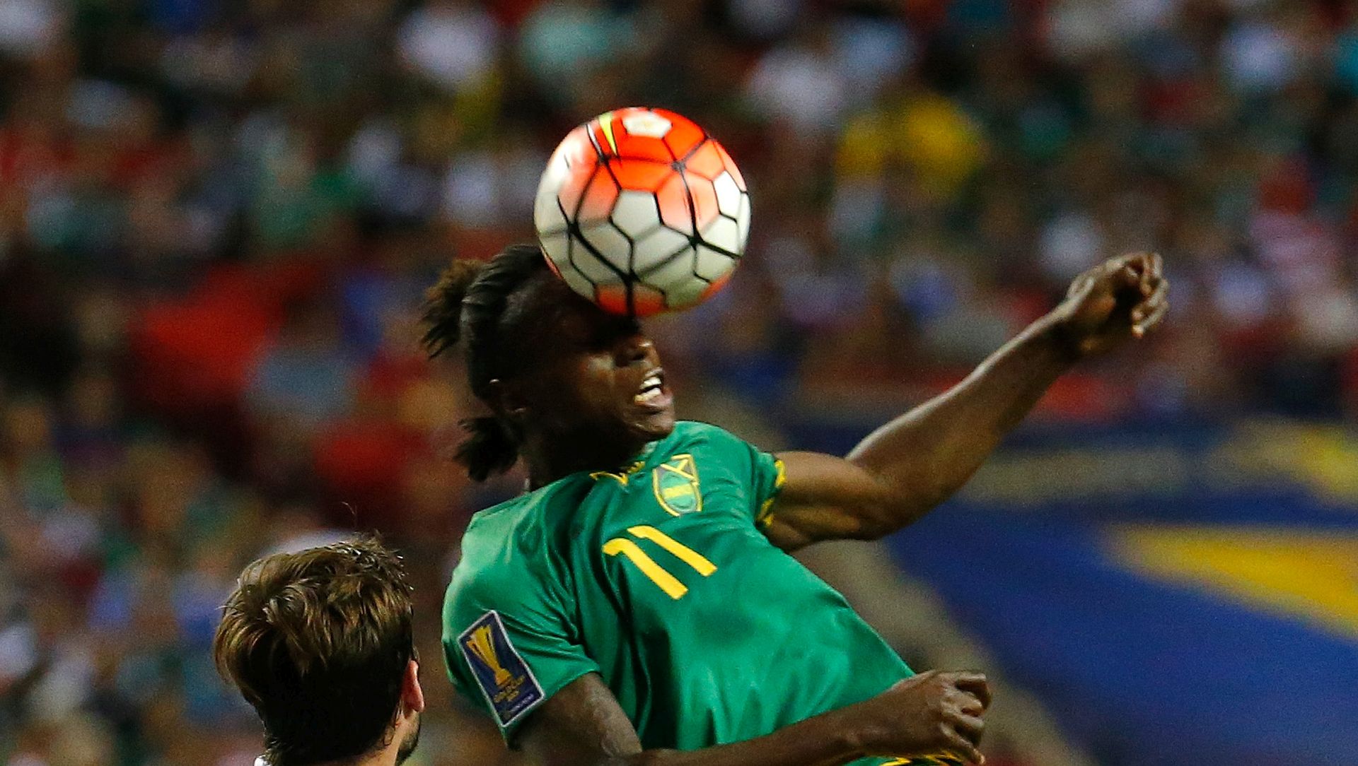 ATLANTA, GA - JULY 22:  Darren Mattocks #11 of Jamaica wins a header against Clint Dempsey #8 and Brad Evans #16 of the United States of America during the 2015 CONCACAF Golf Cup Semifinal match between Jamaica and the United States at Georgia Dome on July 22, 2015 in Atlanta, Georgia.  (Photo by Kevin C. Cox/Getty Images)