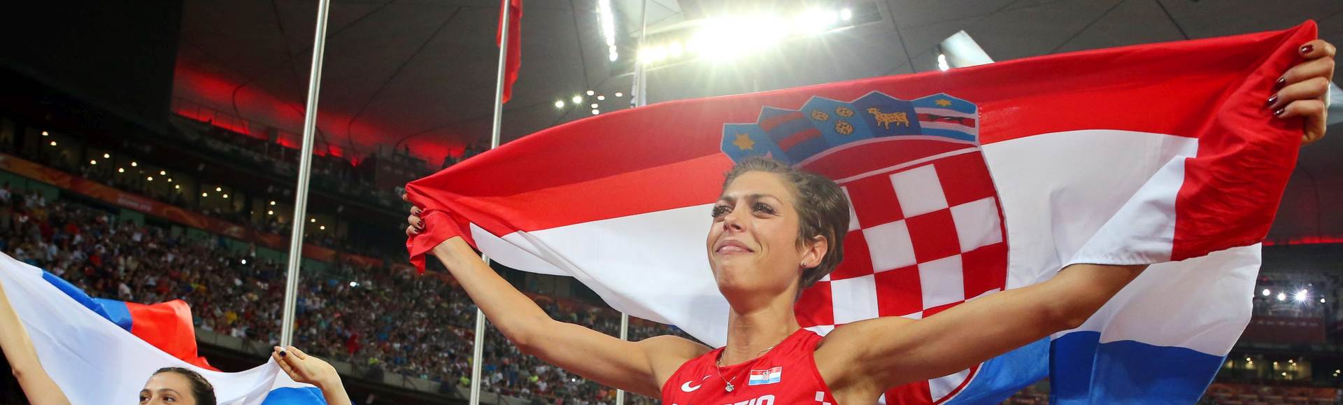 epa04903556 Russia's Maria Kuchina (L) celebrates after winning the gold medal in the women's High Jump final of the Beijing 2015 IAAF World Championships at the National Stadium, also known as Bird's Nest, in Beijing, China, 29 August 2015. Kuchina won ahead of second placed Blanka Vlasic (R) of Croatia.  EPA/DIEGO AZUBEL