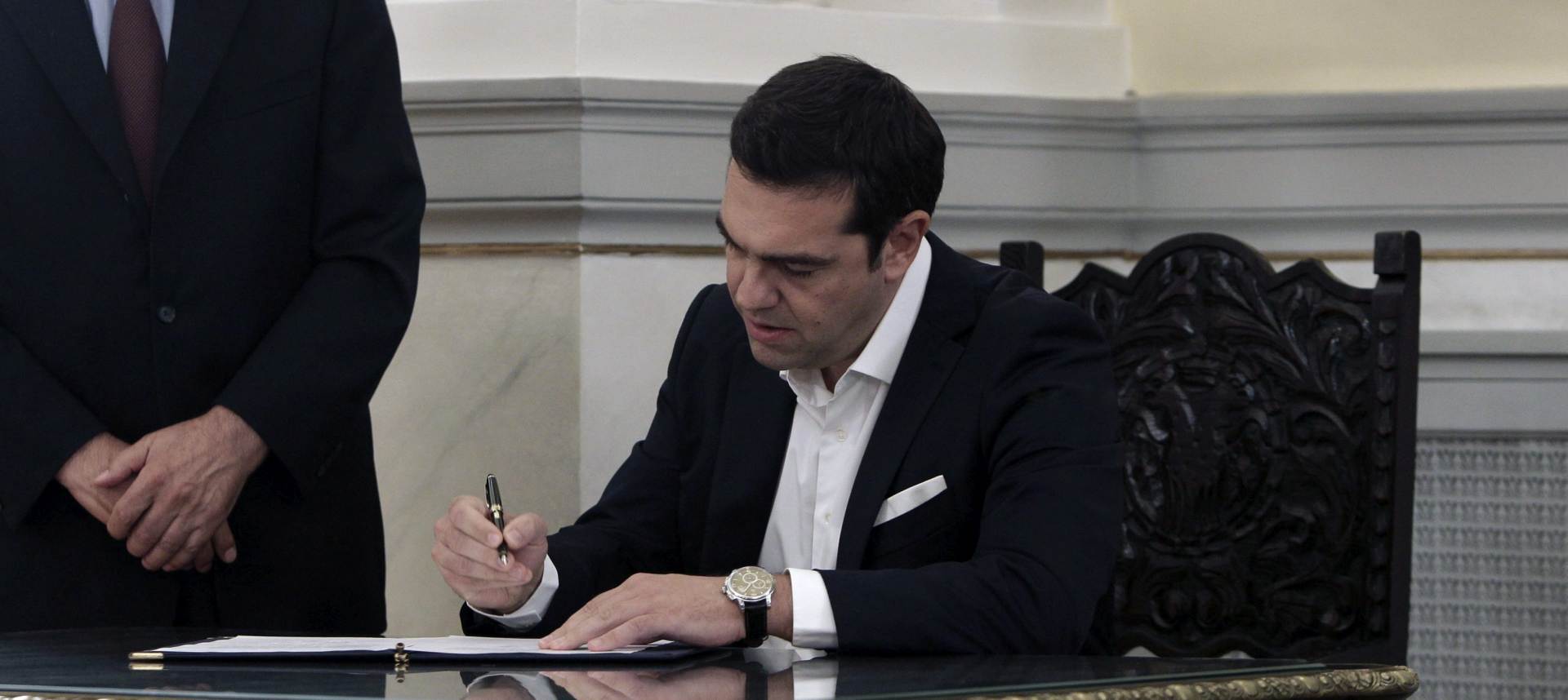 epa04942881 Greek SYRIZA party leader Alexis Tsipras (R) signs documents following his swearing ceremony as new Prime Minister by the country's President Prokopis Pavlopoulos (not pictured) at the presidential palace in Athens, Greece, 21 September 2015. Alexis Tsipras is set to return to power in Greece with another emphatic election victory, vindicating his decision to seek a new mandate after yielding to the demands of European leaders for more austerity in the crisis-hit country.  EPA/YANNIS KOLESIDIS