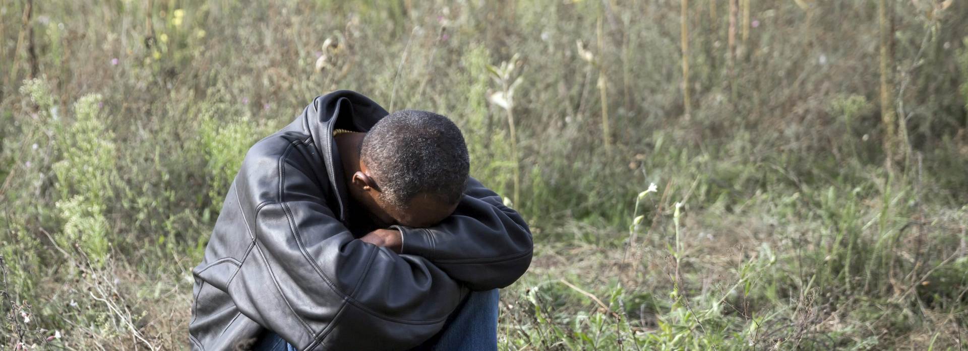 epa04931187 A migrant man rests on the Serbian side of the border between Hungary and Serbia, near Horgos, 15 September 2015. Hungary declared a state of emergency in two counties along the border with Serbia because of the influx of refugees. Hungary said it registered 9,380 illegal crossings, nearly doubling the previous record from 13 September and roughly three times the daily average of recent weeks, as people rushed to make it into the country before the fence closed and new laws kicked in.  EPA/BALAZS MOHAI HUNGARY OUT  EPA/BALAZS MOHAI HUNGARY OUT