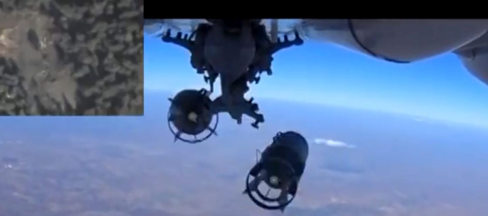 epa04964957 A handout frame grab taken from a video footage made available on the official website of the Russian Defence Ministry on 05 October 2015 shows bombs dropped by a Russian warplane during an airstrike against what Russia says was a large concentration of terrorist Islamic State (ISIS or IS) military equipment in the forest area near the city of Idlib, Syria, and a sub-window in the upper-left coner showing the site targeted for a strike.  EPA/RUSSIAN DEFENCE MINISTRY PRESS SERVICE HANDOUT BEST QUALITY AVAILABLE HANDOUT EDITORIAL USE ONLY/NO SALES