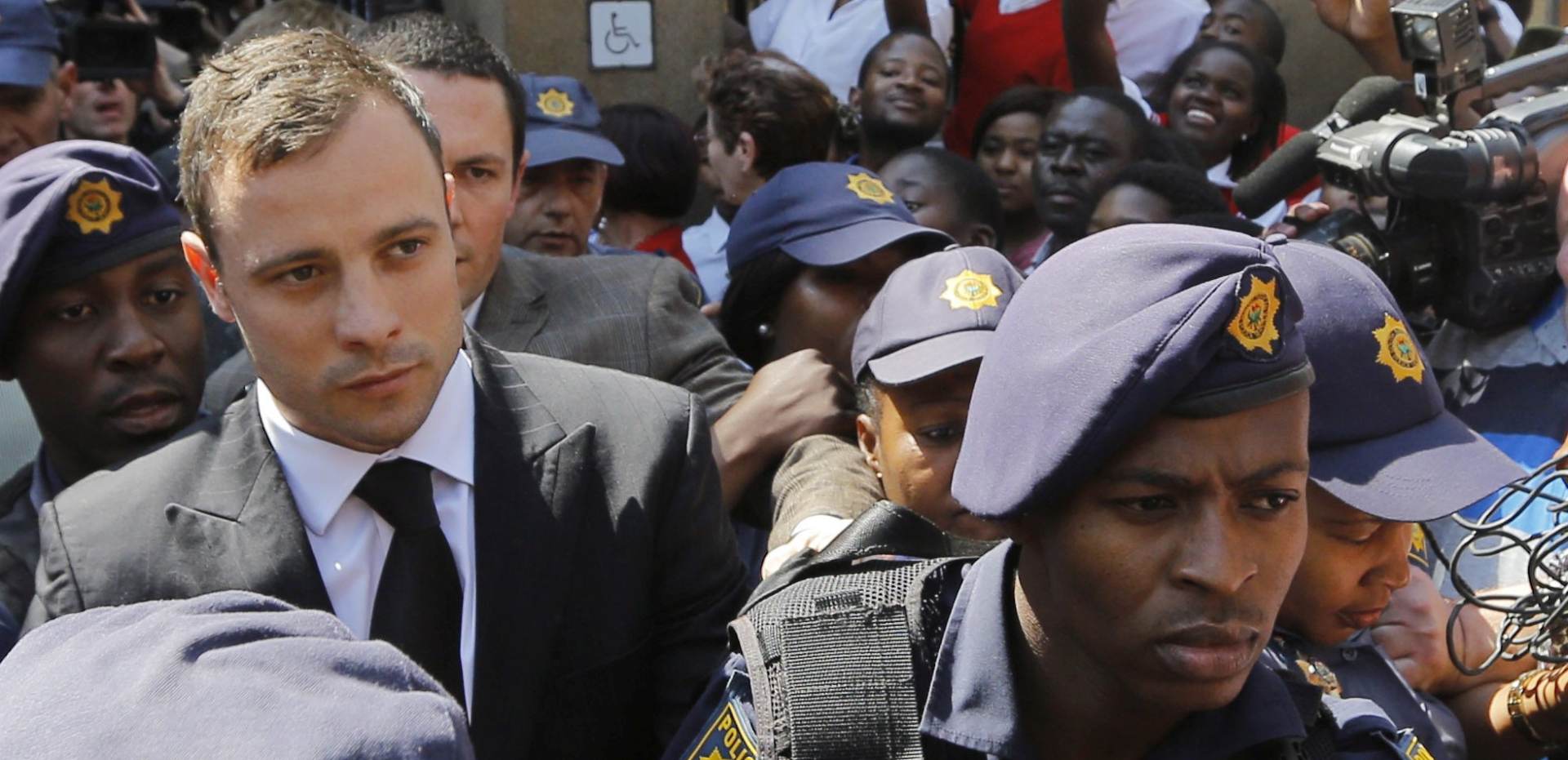 epa04977932 (FILE) A file picture dated 12 September 2014 shows South African Paralympic athlete Oscar Pistorius (C) making his way through a mass of media following judgement in his murder trial at a court in Pretoria, South Africa. South Africa's Correctional Services parole board is scheduled to meet on 15 October 2015, to decide if and when Pistorius should be released. He was sentenced to five years in prison on 21 October 2014. Pistorius was due to be released on 21 August, but his parole was blocked by Justice Minister Michael Masutha at the last minute on the grounds that the decision was 'taken prematurely.'  EPA/KIM LUDBROOK