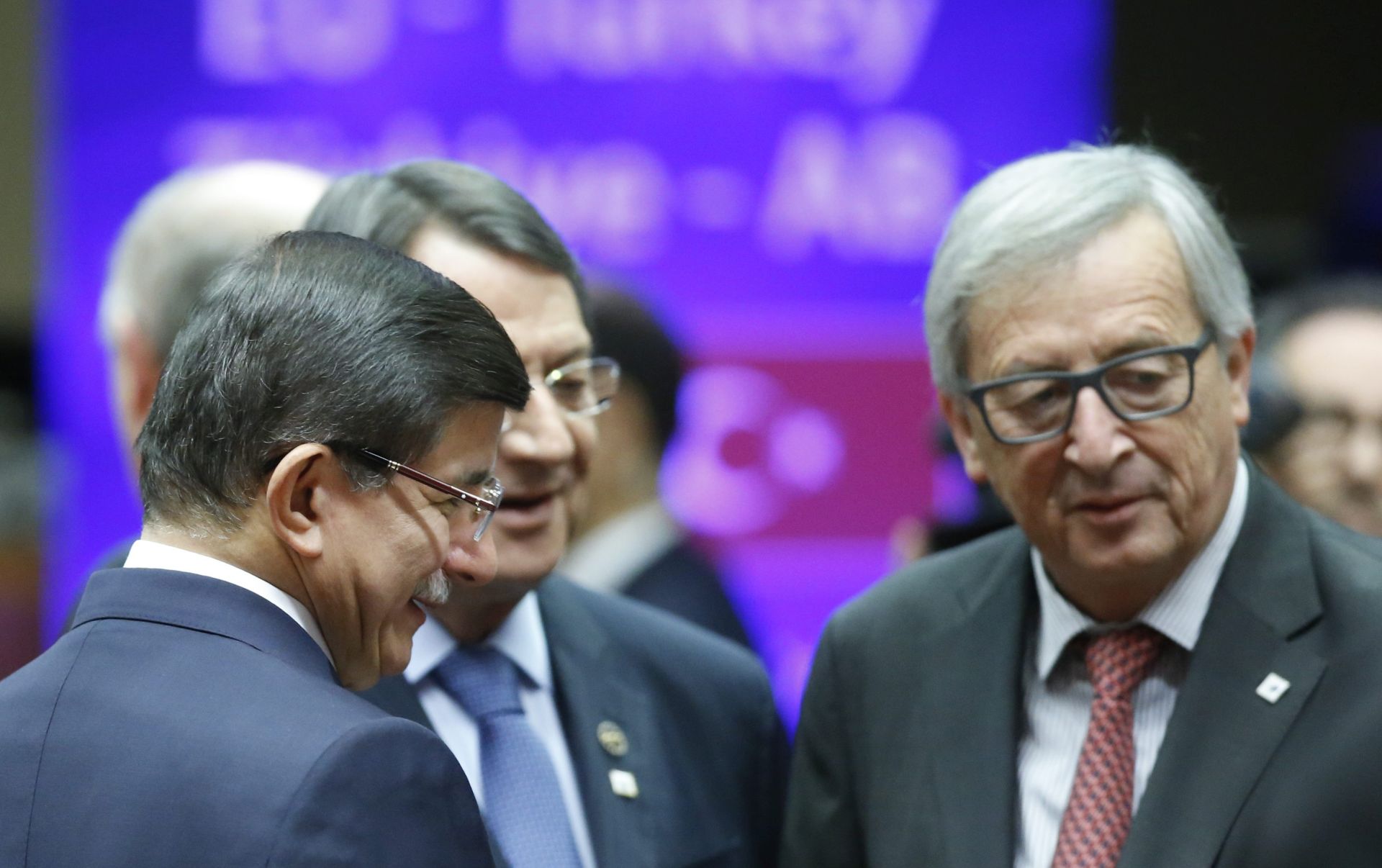 epa05047448 Turkish Prime Minister Ahmet Davutoglu (L-R), Cypriot President Nicos Anastasiades, and European Commission President Jean-Claude Juncker talk at the start of an EU-Turkey Summit in Brussels, Belgium, 29 November 2015. The European Union hopes to secure Ankara's concrete help in stemming a surge in migration, at a joint summit in Brussels, with the bloc offering financial aid and closer ties in return. Europe is facing its largest people movements since World War II, with almost 900,000 migrants and asylum seekers arriving this year. Many, including large numbers from war-torn Syria, transit through Turkey and board boats headed for Greece.  EPA/OLIVIER HOSLET