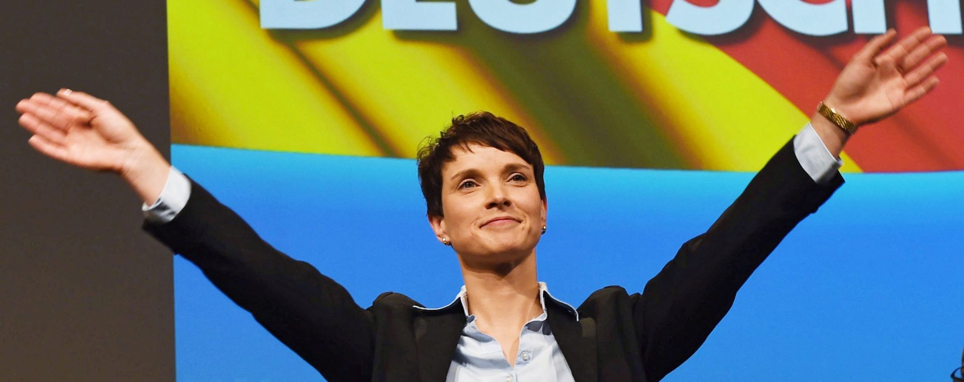 epaselect epa05045447 Frauke Petry, co-chairwoman of Alternative for Germany (AfD) party, waves under the writing 'GERMAN' after her speech at the AfD federal convention in Hanover, Germany, 28 November 2015. Populist anti-immigrant AfD party will hold their federal convention on 28 and 29 November 2015 with asylum policy and influx of refugees topping the agenda.  EPA/SWEN PFOERTNER