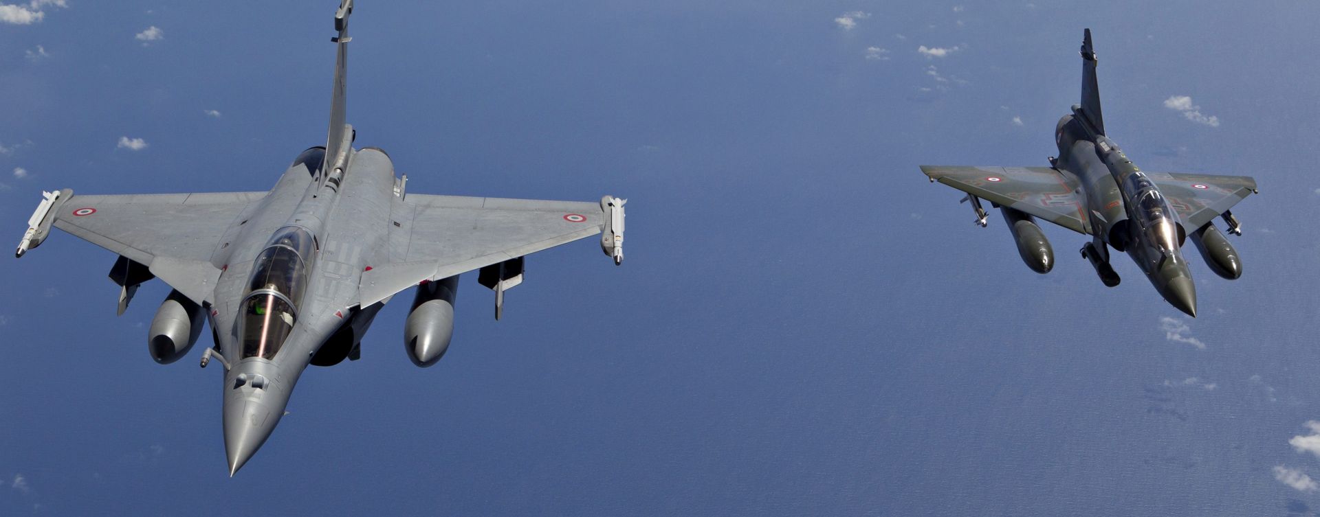 epa05027386 (FILE) A file handout photograph issued by the French Ministry of Defense 31 March 2011 shows a French Mirage 2000D (R) and a French Rafale fighter jet in flight, at an undisclosed location, 30 March 2011. The French Air Force on 15 November 2015 launched a massive campaign of airstrikes against the Islamic State in its stronghold of al-Raqqa in Syria, the French news agency AFP reports, citing the Defence Ministry. The airstrikes come after at least 132 people were killed and some 350 injured in the terror attacks which targeted the Bataclan concert hall, the Stade de France national sports stadium, and several restaurants and bars in Paris on 13 November. Authorities believe that three coordinated teams of terrorists armed with rifles and explosive vests carried out the attacks, which the Islamic State (IS) extremist group has claimed responsibility for.  EPA/AMBOISE/ECPAD/SIRPA AIR/HANDOUT  HANDOUT EDITORIAL USE ONLY/NO SALES