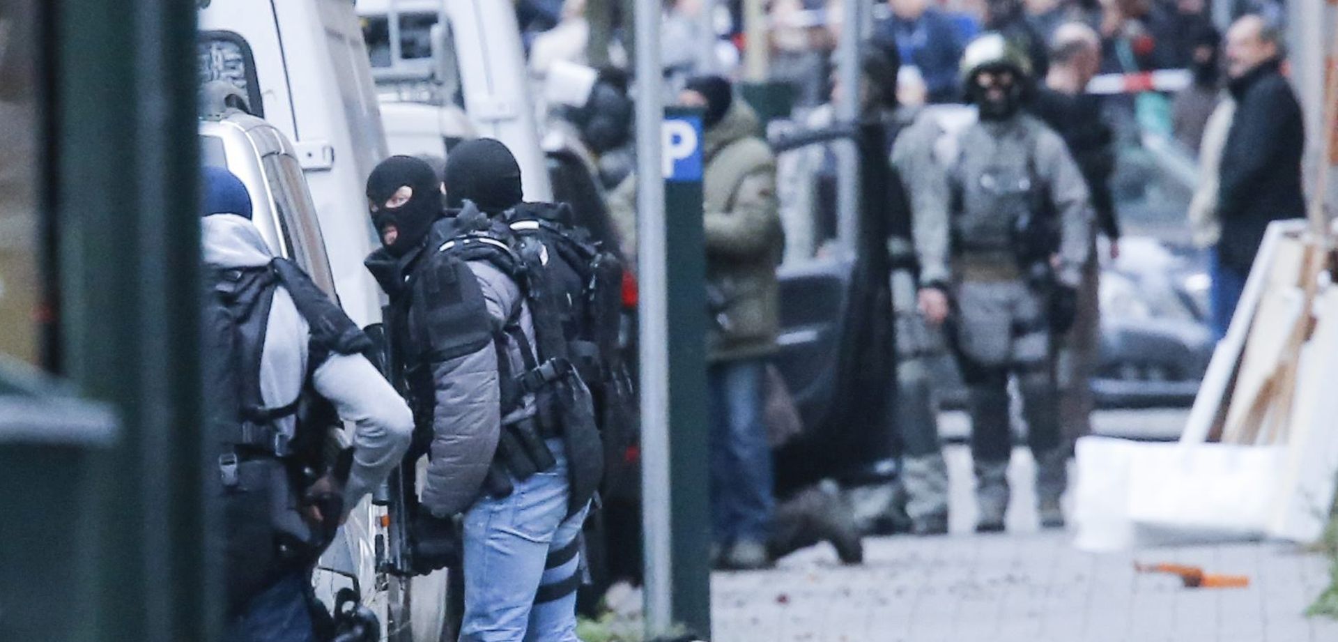 epa05027884 epa05027865 Riot Police in action  at rue Delaunoy in the streets of Molenbeek, Brussels, Belgium, 16 November 2015. More than 130 people were killed and hundreds injured in the terror attacks which targeted the Bataclan concert hall, the Stade de France national sports stadium, and several restaurants and bars in the French capital on 13 November. Authorities believe that three coordinated teams of terrorists armed with rifles and explosive vests carried out the attacks, which the Islamic State (IS) extremist group has claimed responsibility for.  EPA/OLIVIER HOSLET  EPA/OLIVIER HOSLET