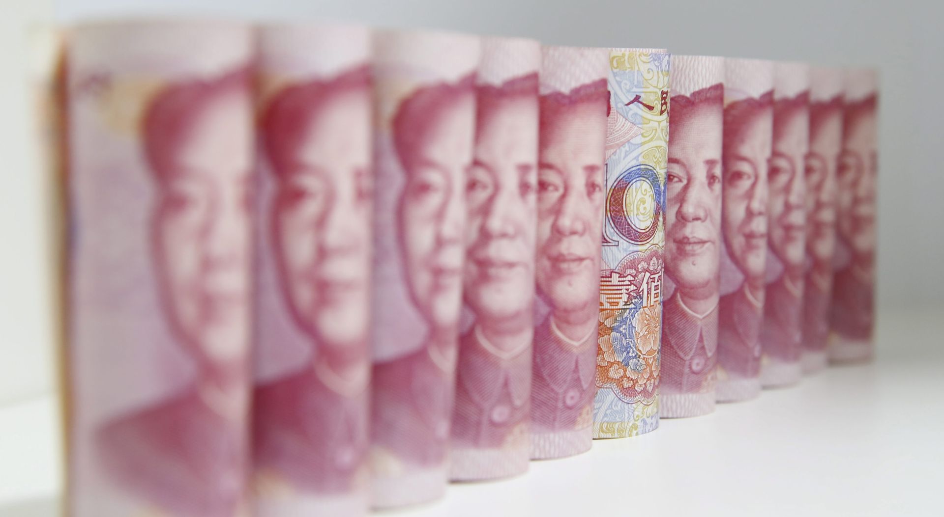 epa05049745 (FILE) A file picture dated 12 AUgust 2015 of Chinese 100 Yuan or Renminbi (RMB) arranged for a picture on a table in Beijing, China. The International Monetary Fund (IMF) on 30 November 2015 announced it is adding China's renminbi, or Yuan, to the currencies that the Washington-based crisis lender uses as a measure of value, alongside the dollar, euro, yen and pound sterling.  EPA/WU HONG