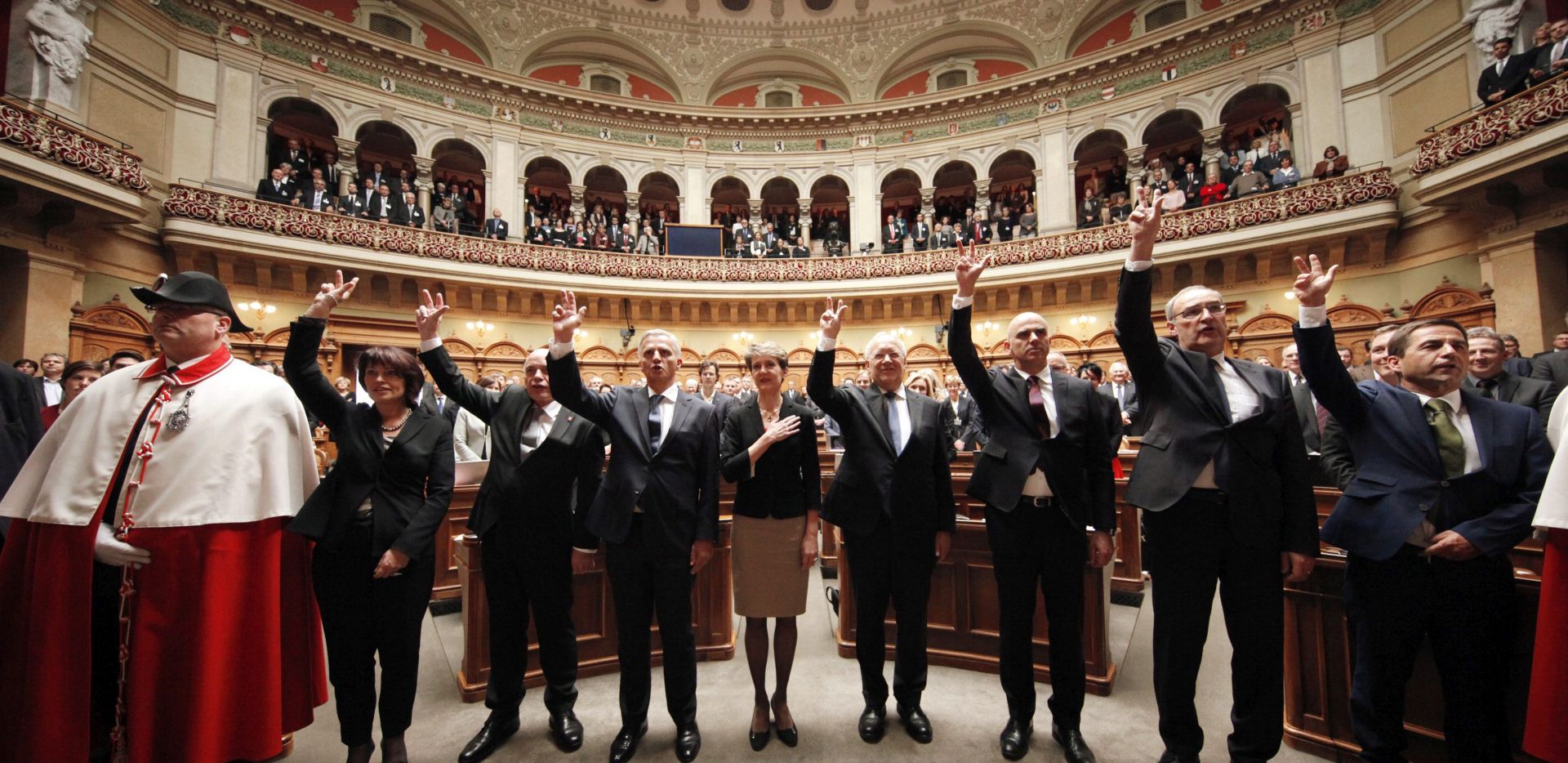 epa05061240 (L-R) Swiss Federal Councillors Doris Leuthard, Ueli Maurer, Didier Burkhalter, Simonetta Sommaruga, Johann Schneider-Ammann, Alain Berset, Guy Parmelin and Walter Thurnheer, Head of the Federal Chancellery, are sworn-in after the election of the members of the Swiss Federal Council during the winter Parliament Session in Bern, Switzerland, 09 December 2015.  EPA/RUBEN SPRICH / POOL