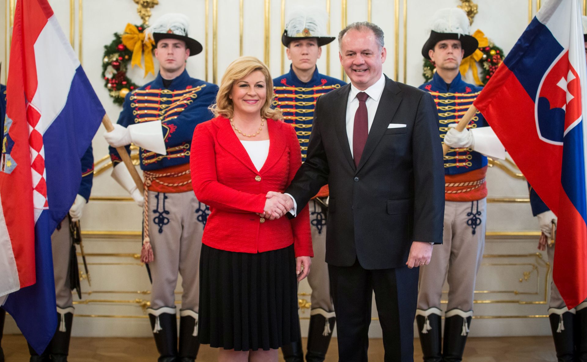 epa05060855 Croatian President Kolinda Grabar Kitarovic (L) and Slovakian President Andrej Kiska (R) prior to their meeting in Bratislava, Slovakia, Slovakia, 09 December 2015. Kolinda Grabar Kitarovic will hold discussions relating to bilateral relations among other topics during her two day visit.  EPA/JAKUB GAVLAK