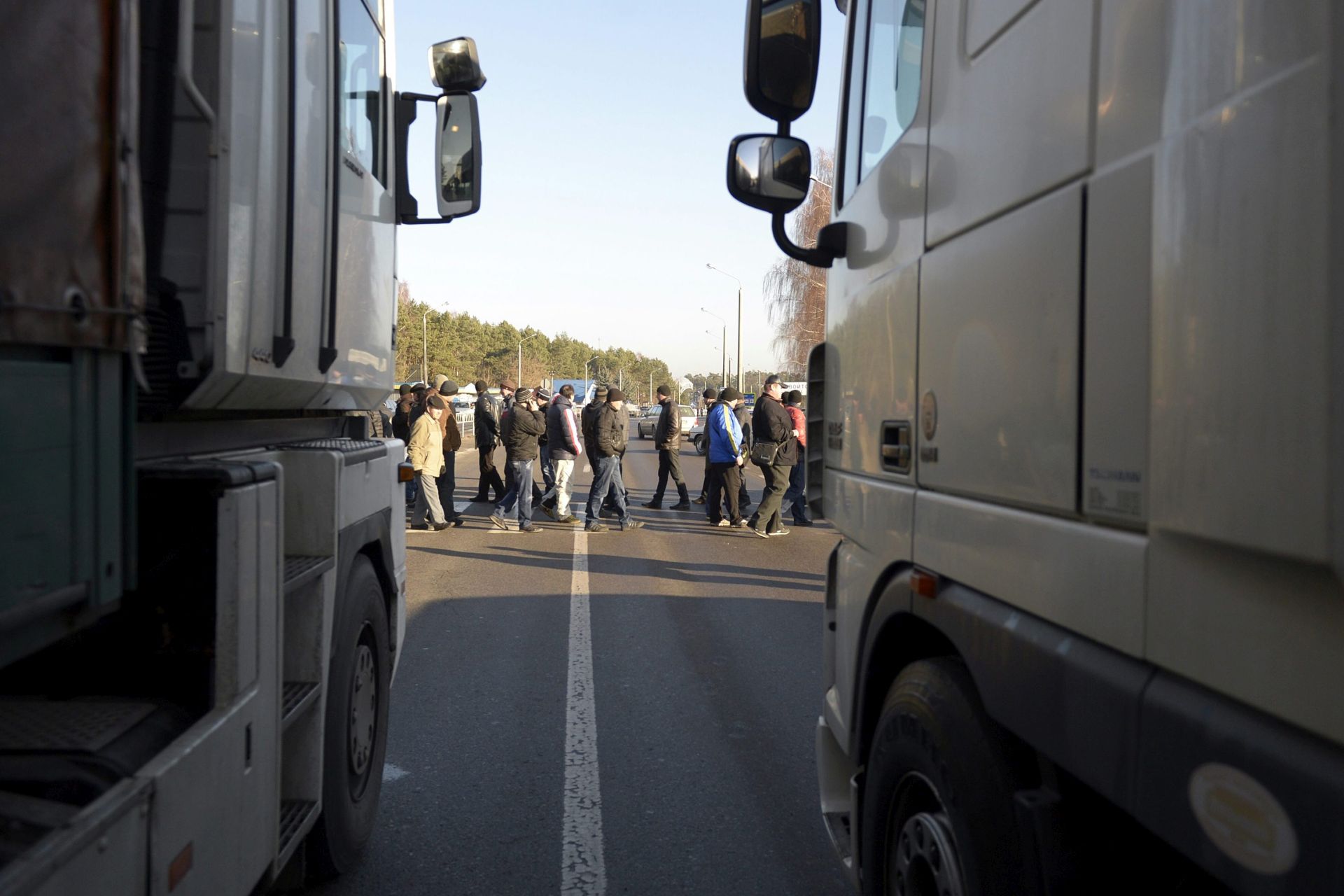epa05064820 Trucks stand in line as Ukrainian Volyn Oblast miners block the road in the Jahodin (Jagodzin) village, near the Polish-Ukrainian border crossing Dorohusk-Jagodzin, in Ukraine, 11 December 2015. The miners from state mines, demand overdue wages, which they don't receive since two and a half months and protest against planned changes to the labor code and deteriorating employment conditions in the mining industry.  EPA/DAREK DELMANOWICZ POLAND OUT
