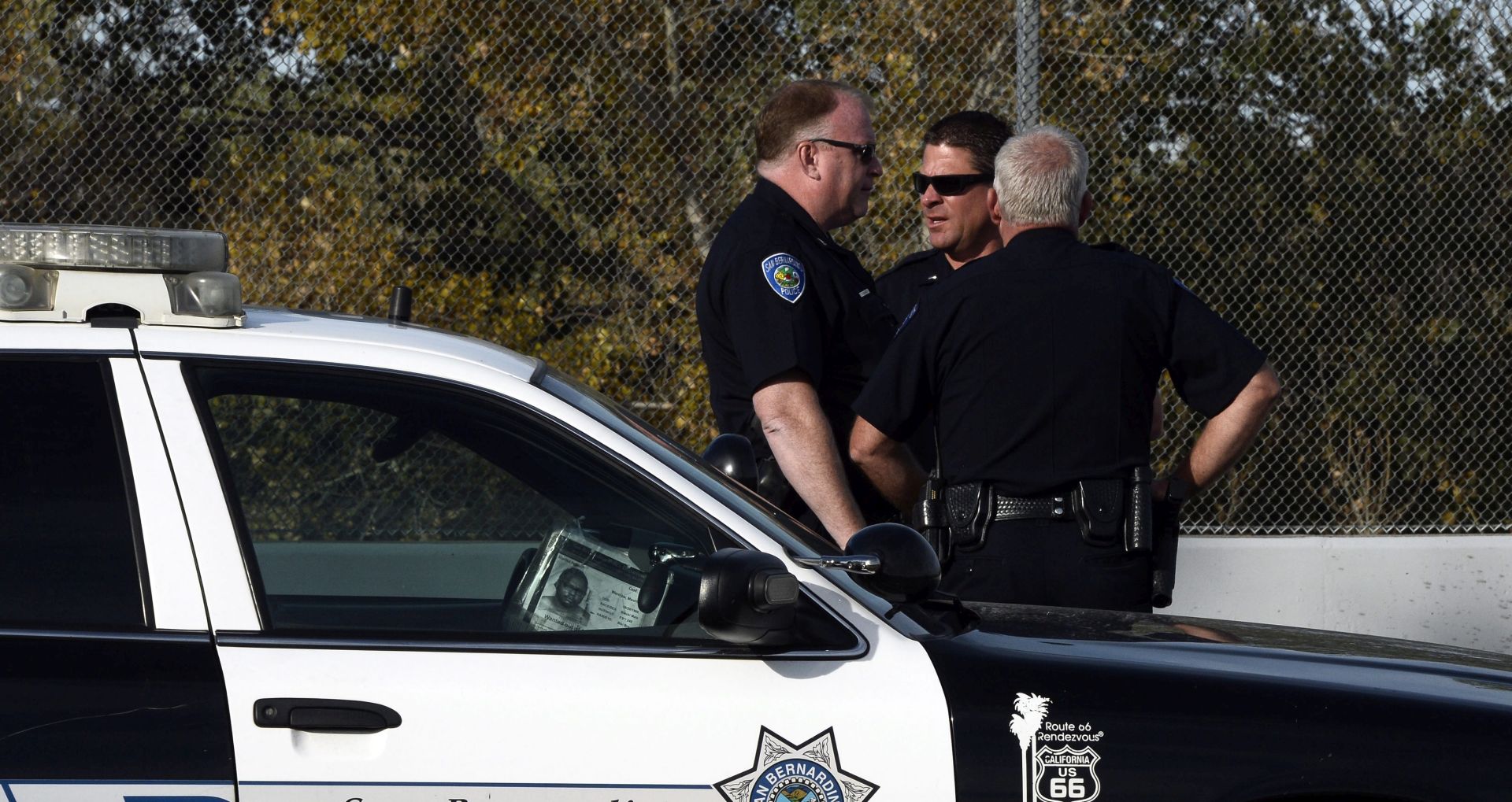 epa05053464 Law enforcement officers gather near the crime scene in the aftermath of the deadly mass shooting in San Bernardino, California, USA 03 December 2015. The shooting spree in which 14 people were killed and 17 wounded in San Bernardino was carried out by a local couple, police said overnight. The suspects, who died in a shootout with police hours after the massacre 02 December at a conference centre, were Syed Rizwan Farook, 28, and Tashfeen Malik, 27, the San Bernardino County Sheriff's Office said.  EPA/PAUL BUCK