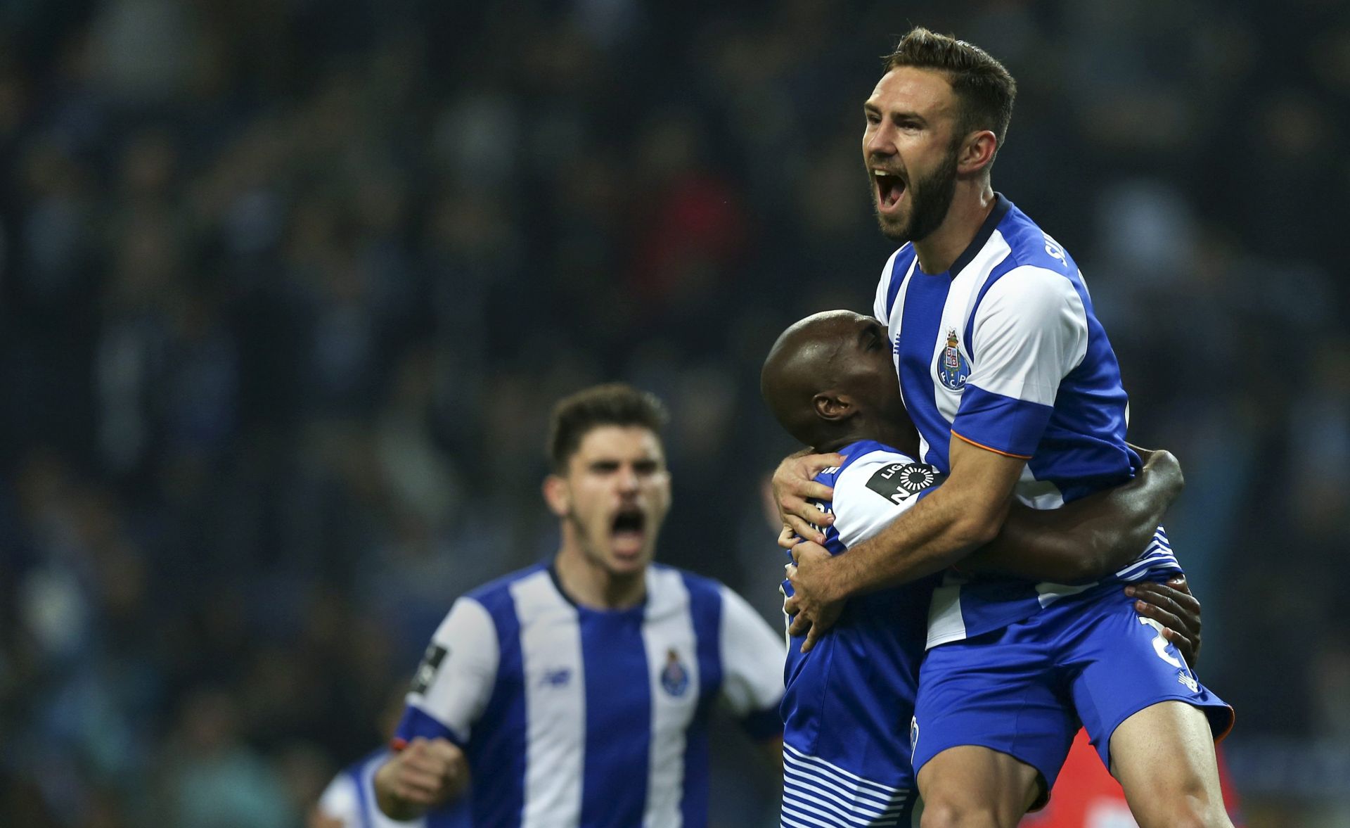 epa05056053 FC Porto's Miguel Layun (R) celebrates with his teammates Bruno Martins Indi (L) after scoring a goal against Pacos de Ferreira during the Portuguese First League soccer match held at Dragao stadium in Porto, Portugal, 05 December 2015.  EPA/ESTELA SILVA