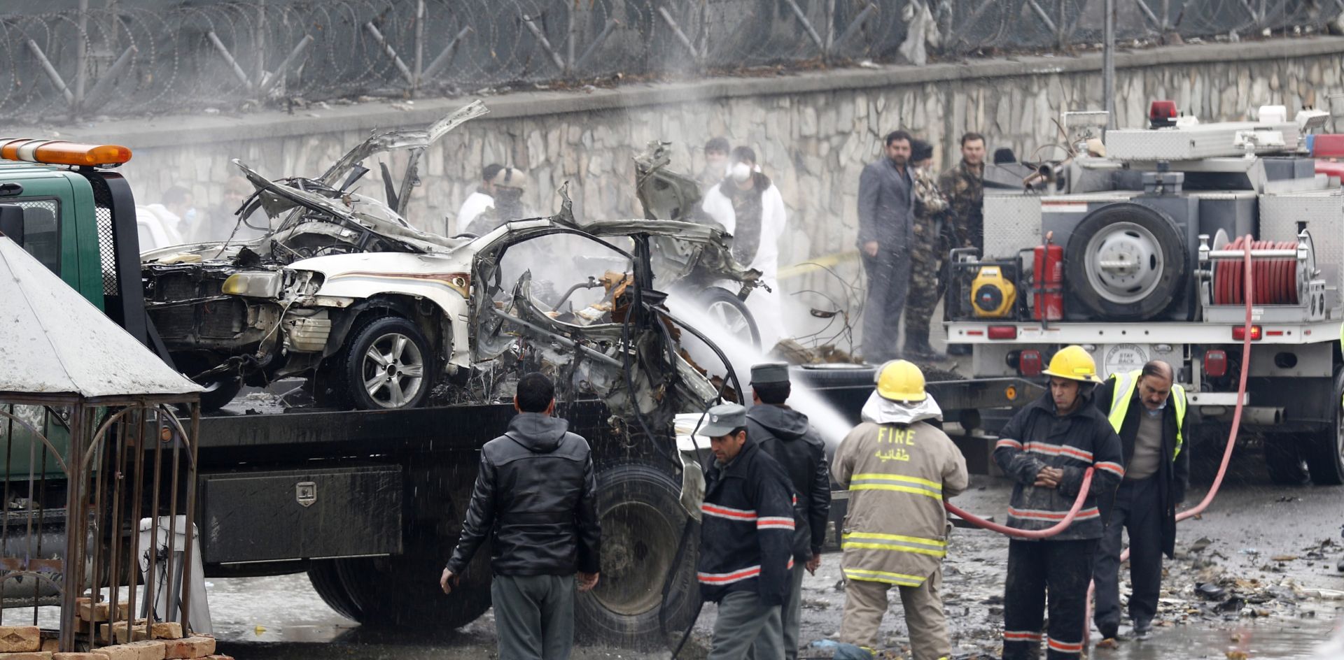 epa05087433 Afghan security officials inspect the scene of a suicide bomb attack at police checkpoint near Kabul International Airport in Kabul, Afghanistan, 04 January 2016. A suicide bomber detonated his explosives at a police checkpoint near Kabul airport on Monday, officials said. There were no immediate reports of casualties or injuries. General Ahmad Farid Afzali, head of the Kabul police criminal investigation unit, said that the bomber blew up his explosives inside a vehicle near the checkpoint.  EPA/JAWAD JALALI
