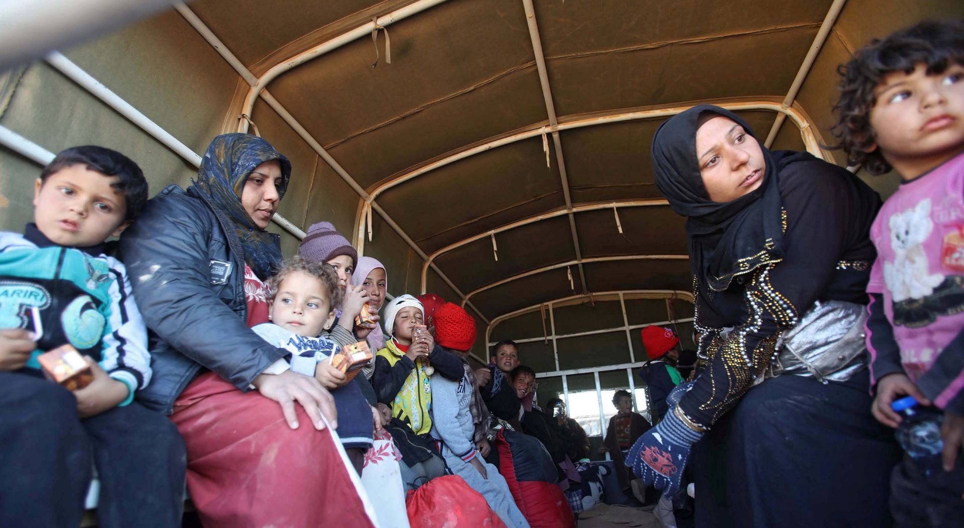 epa05102348 Syrian refugees arrive on a truck after crossing in at the north-eastern Jordan border with Syria, near Royashed Town, Jordan, 14 January 2016. According to the Jordanian news agency Petra, the Jordan Response Plan 2015' (JRP 2015) estimates the total number of Syrian refugees to be around 1.5 million, almost 650,000 of which are registered as refugees.  EPA/STR