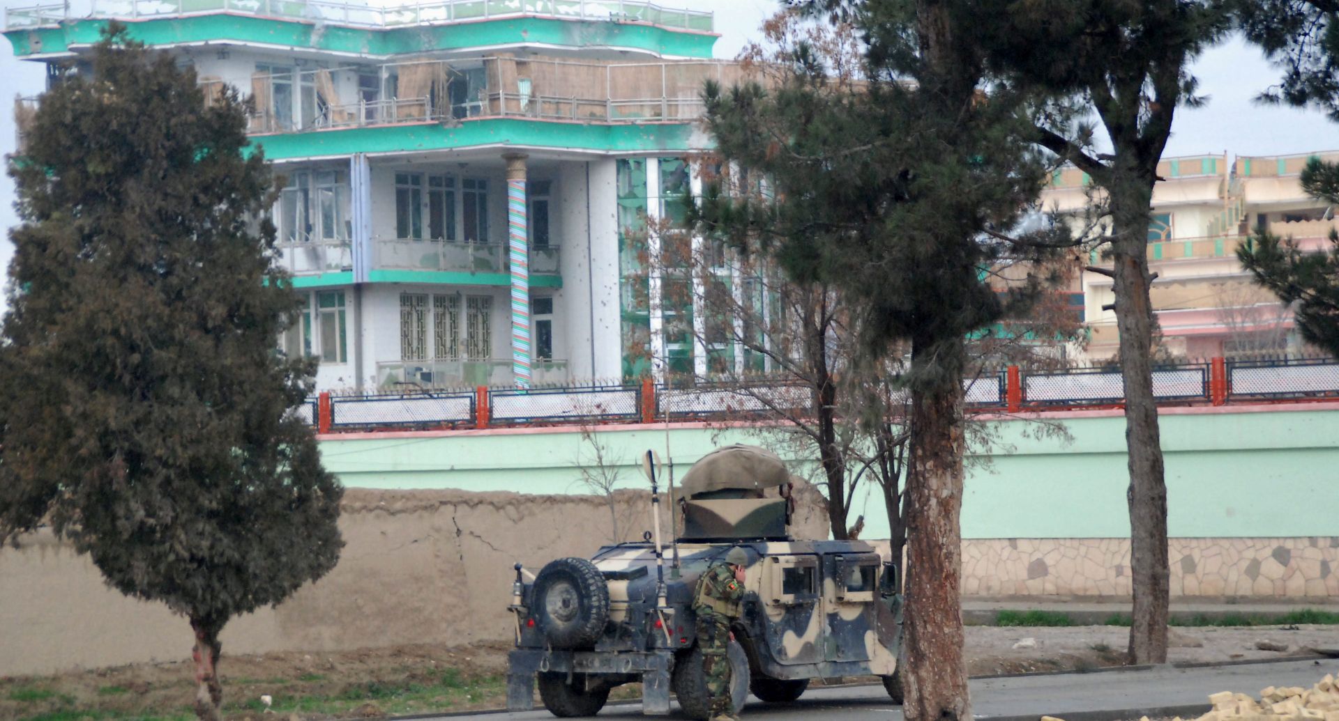 epa05087369 Afghan security officials secure the area of Indian Consulate after a suspected militants attack in Mazar-e-Sharif, Afghanistan, 04 January 2016. At least one security guard and two attackers have died in an ongoing siege near the Indian consulate in the northern Afghan city of Mazar-e Sharif, a spokesman said on 04 January. Approximately four assailants are holed up in a nearby three-storey building where they are resisting the security forces.  EPA/MUTLIB SULTANI