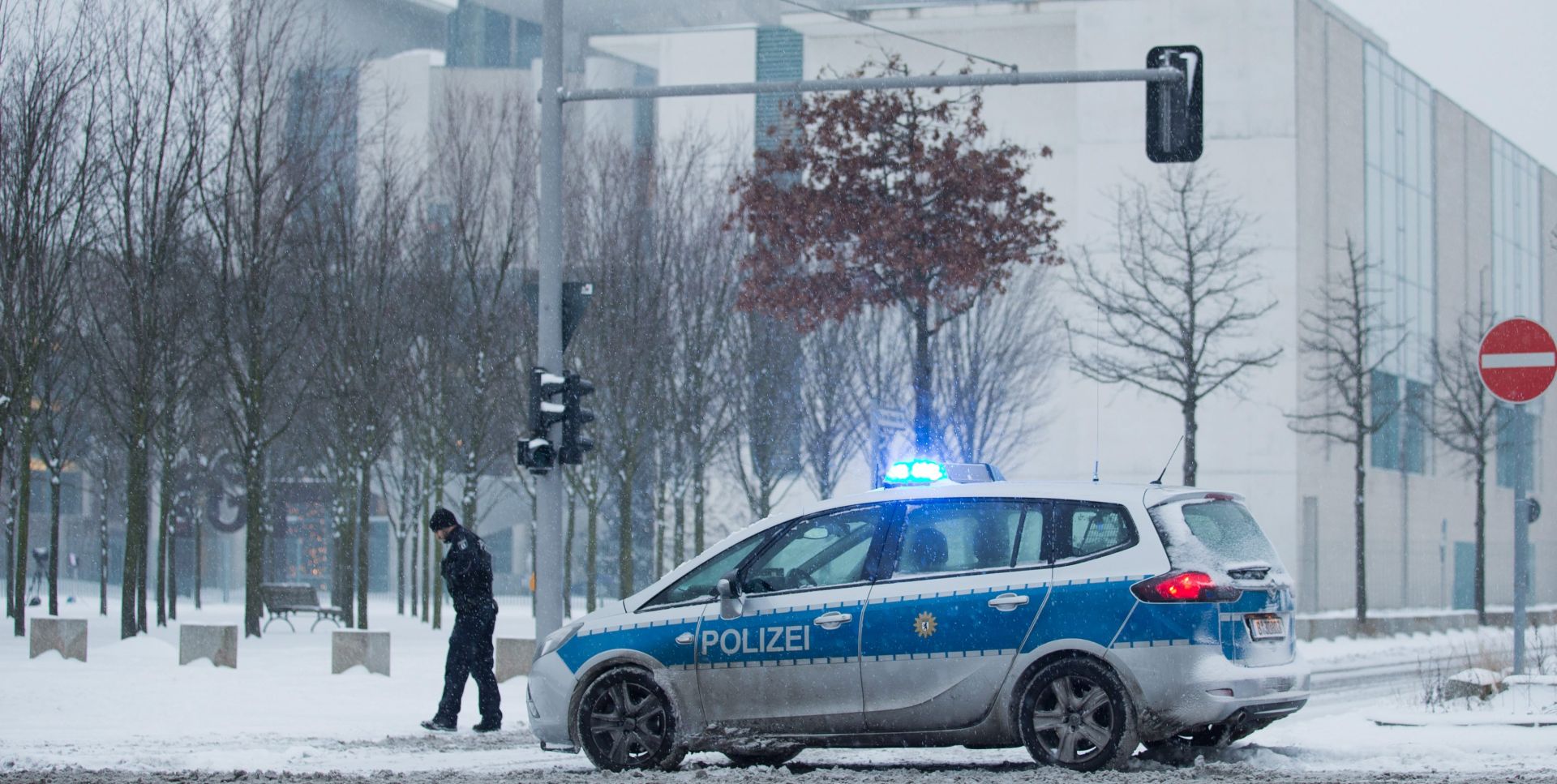 epa05089524 A police car parked in the snow in front of the German Chancellery in Berlin, Germany, 06 January 2016. Explosives experts were examining a suspicious package that arrived at the German Chancellery early on 06 January and caused part of the government building to be closed off, police said. The package had raised suspicions as it went through the usual security checks and investigations are ongoing, the police spokesman said.  EPA/MICHAEL KAPPELER