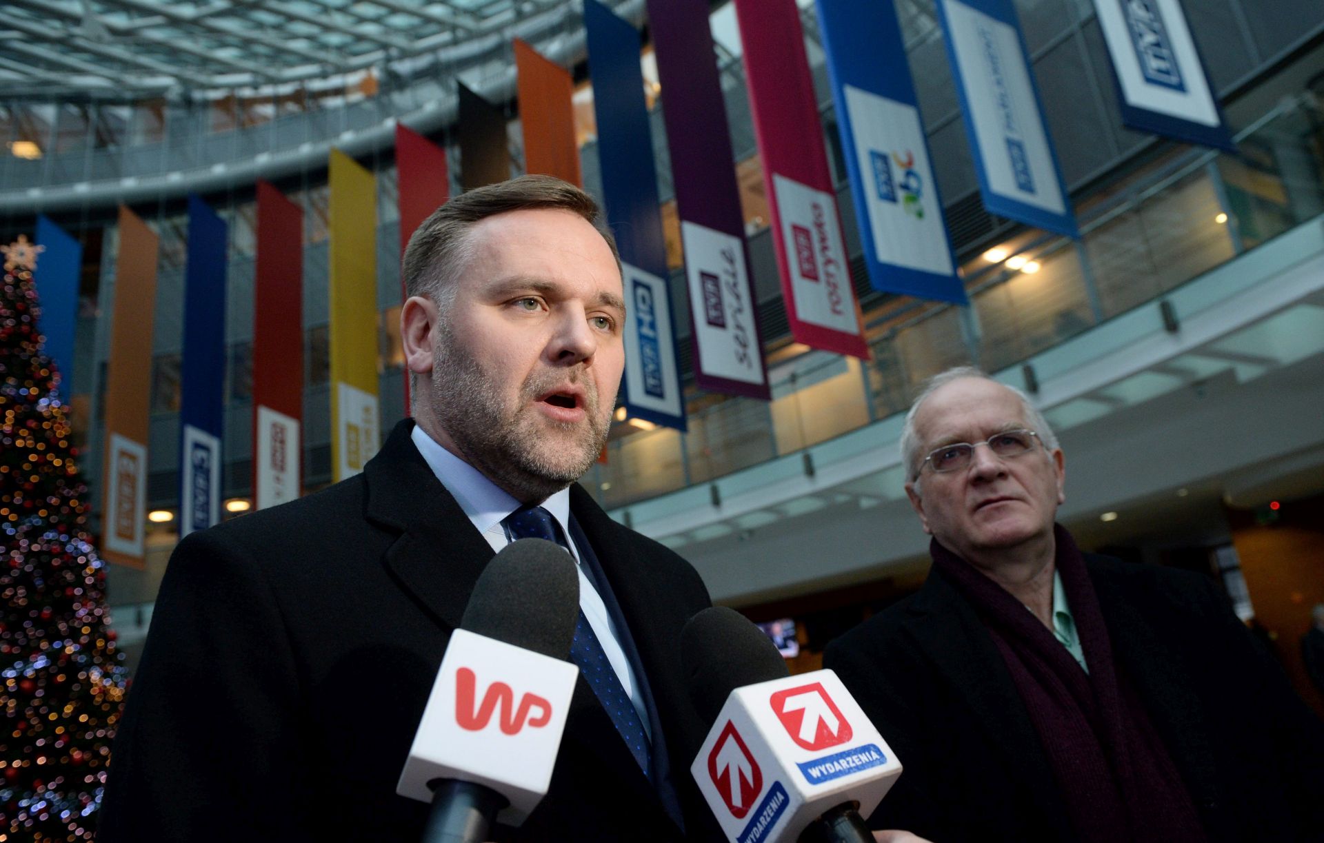 epa05092393 Polish Treasury Minister Dawid Jackiewicz (L) with Polish Deputy Culture Minister Krzysztof Czabanski (R) speak with media at the Polish Television TVP in Warsaw, Poland, 08 January 2015. Minister Jackiewicz appointed Jacek Kurski (not seen) president of Polish Television (TVP) and Barbara Stanislawczyk president of Polish Radio. The changes are the effect of recent amendments to Poland's broadcasting law which came into force on Friday 08 january 2016. Under the new law, the current public TV and radio companies will be transformed into state-owned legal entities, new management and supervisory boards will be appointed by the Treasury minister 'until the introduction of a new organisation of national media'. The amended law will be in force until 30 June 2016.  EPA/JACEK TURCZYK POLAND OUT