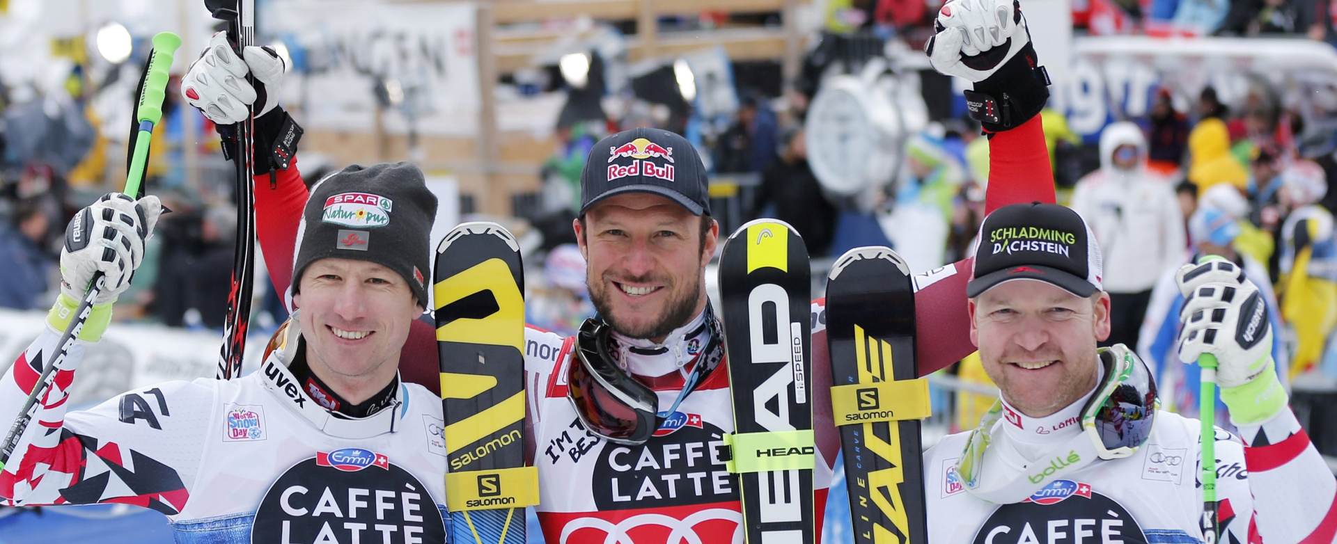 epa05104907 Hannes Reichelt of Austria (2nd), Aksel Lund Svindal of Norway (winner) and Klaus Kroell of Austria (3rd), from left, celebrate in the finish area during the Downhill race of the FIS Alpine Ski World Cup season at the Lauberhorn in Wengen, Switzerland, 16 January 2016.  EPA/PETER KLAUNZER