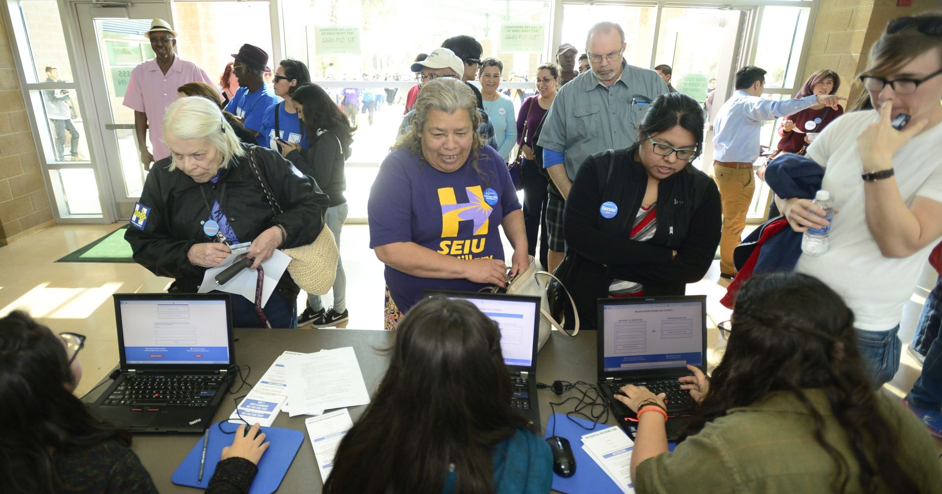 epa05172823 Caucus goers register as they prepare to indicate their presidential candidate  preference in the Nevada Democratic Presidential candidates caucus at Rancho High School in Las Vegas, Nevada, USA, 20 February 2016. Former Secretary of State Hillary Clinton and US Senator Bernie Sanders are locked in a tight race for the Nevada Caucus which will be held on 20 February 2016.  EPA/MIKE NELSON