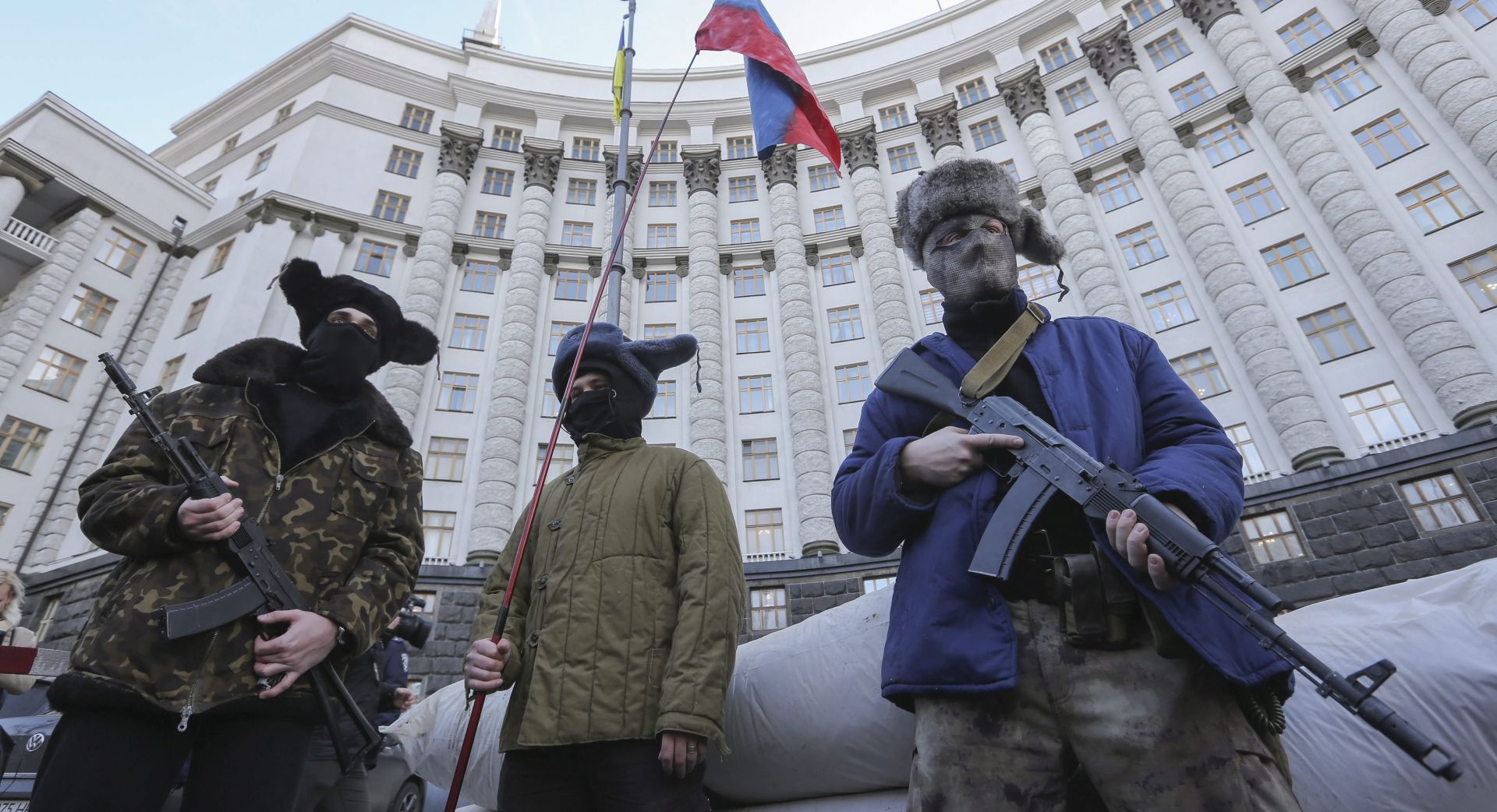 epa05162288 Ukrainian activists dressed like armed pro-Russian rebels perform during their rally in in front of the Government building in Kiev, Ukraine, 15 February 2015. The protesters demanded that all Russian businesses are banned in Ukraine. Relations between Russia and Ukraine are still tense after Ukraine ousted its pro-Russian president during mass protests 2014, calling for closer ties with the West. Russia subsequently occupied and annexed Ukraine's southern Crimea region and supported a pro-Russian separatist rebellion in Ukraine's two eastern-most regions.  EPA/VOLODYMYR PETROV