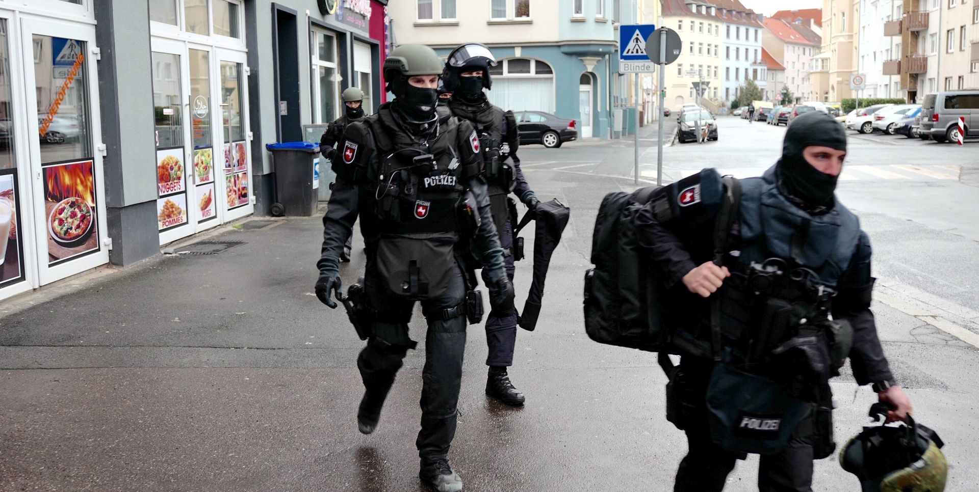 epa05142292 Members of the German police leave an apartment following a raid in Hanover, Germany, 04 February 2016. Two suspected Islamists were arrested in a series of coordinated raids across Germany prompted by a tip-off of a terrorist attack, security sources said. The raids were conducted in Berlin, Hanover and the town of Attendorn in North Rhine-Westphalia, and two out of four Algerian suspects wanted by police are now in custody. Police received a tip-off of a terrorist attack from Germany's domestic intelligence agency. The location of the planned attack is not known.  EPA/UWE DILLENBERG