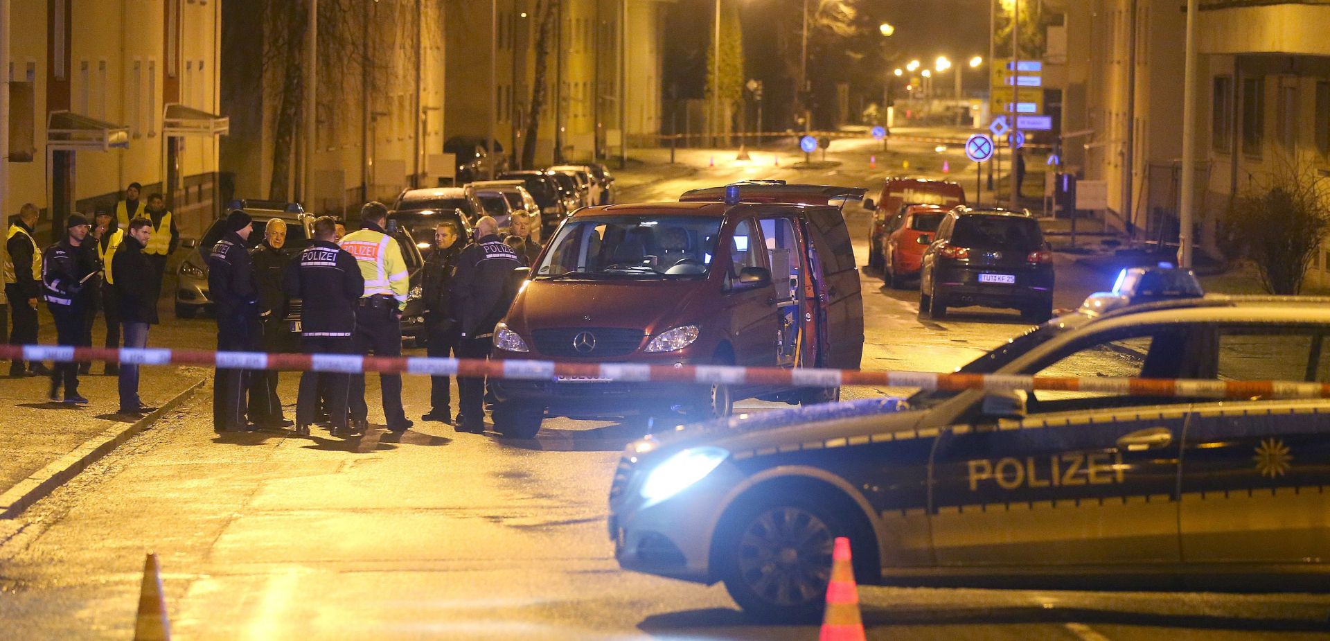 epa05132668 Police forces cordon off a crime scene on a street in front of a refugee shelter in Villingen-Schwenningen, Germany, 29 January 2016. A hand grenade was thrown onto the grounds of the shelter in alleged attack the night before. Security personnel found the grenade which didn't explode even though the safety pin had been removed. The culprits remain unknown.  EPA/MARC EICH