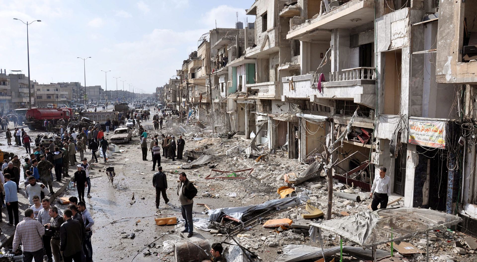 epa05173426 Syrian policemen and citizens inspect the site of a twin bomb attack in the city of Homs, Syria, 21 February 2015. The death toll from the double bomb attack in the Syrian city of Homs rose to 46, including at least 28 civilians, the Syrian Observatory for Human Rights reported. The blasts occurred in the city's Zahraa neighbourhood, populated mainly by members of President Bashar al-Assad's Alawite sect, the Osbervatory said. Alawite districts of the central Syrian city have seen numerous deadly bombings, mostly claimed by the Islamic State and the al-Nusra Front jihadist groups.  EPA/STR