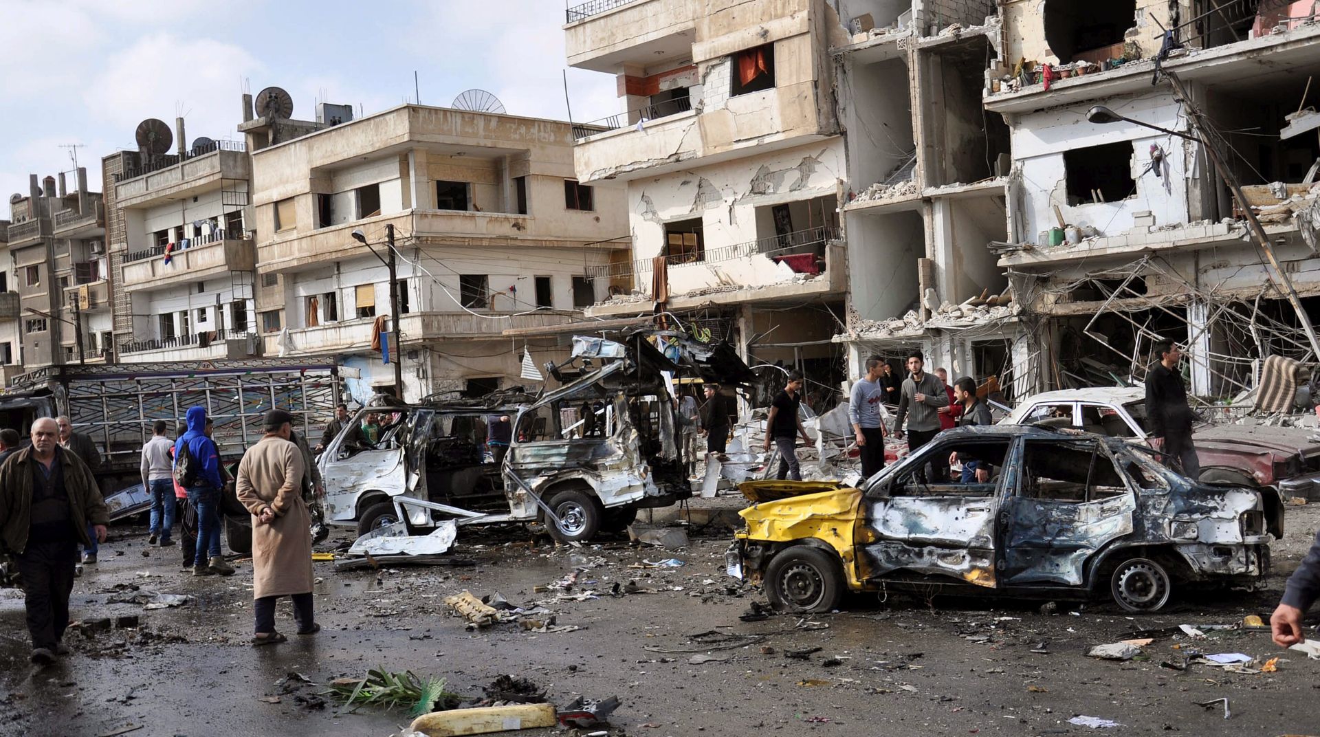 epa05173428 Syrian policemen and citizens inspect the site of a twin bomb attack in the city of Homs, Syria, 21 February 2015. The death toll from the double bomb attack in the Syrian city of Homs rose to 46, including at least 28 civilians, the Syrian Observatory for Human Rights reported. The blasts occurred in the city's Zahraa neighbourhood, populated mainly by members of President Bashar al-Assad's Alawite sect, the Osbervatory said. Alawite districts of the central Syrian city have seen numerous deadly bombings, mostly claimed by the Islamic State and the al-Nusra Front jihadist groups.  EPA/STR