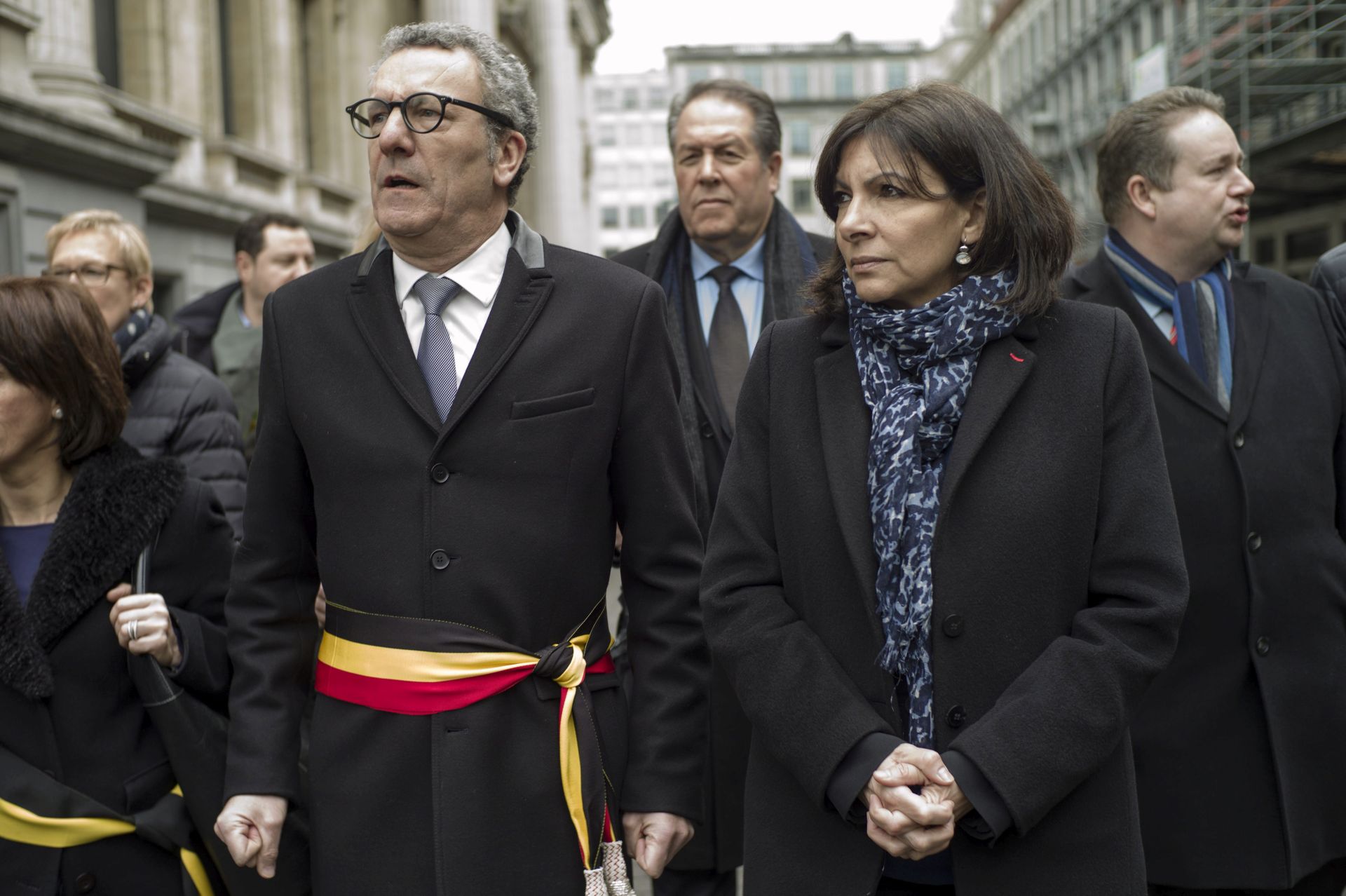 epa05227383 Mayor of Brussels Yvan Mayeur (C-L) and Mayor of Paris Ann Hidalgo (C-R) pay tribute to the many people killed and injured in multiple terror attacks accross Brussels on 22 March, at Place de la Bourse, Brussels, Belgium, 23 March 2016. Security services are on high alert following two explosions in the departure hall of Zaventem Airport and one at Maelbeek Metro station in Brussels. Over 30 people were killed and even more were injured in the attacks which Islamic State (IS) has since claimed responsibility for.  EPA/YOAN VALAT