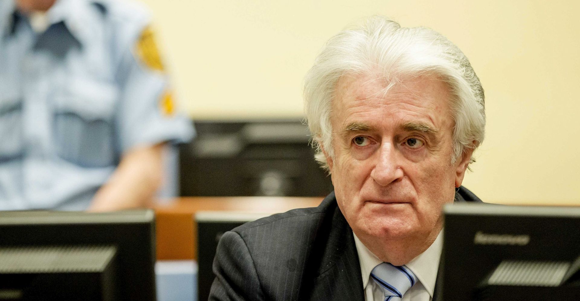 epa05228965 Bosnian Serb wartime leader Radovan Karadzic (R) sits in the courtroom for the reading of his verdict at the International Criminal Tribunal for Former Yugoslavia (ICTY) in The Hague, The Netherlands.The former Bosnian-Serbs leader is indicted for genocide, crimes against humanity, and war crimes. Karadzic is considered the main responsible for the Srebrenica massacre.  EPA/ROBIN VAN LONKHUIJSEN
