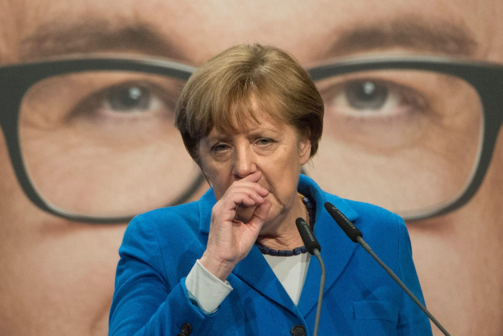 epa05201487 German Chancellor Angela Merkel attends a campaign event for the Baden-Wuerttemberg CDU (Christian Democratic Union) parliamentary elections in Nuertingen, Germany, 08 March 2016. In the background is an image of CDU frontrunner Guido Wolf.  EPA/MARIJAN MURAT