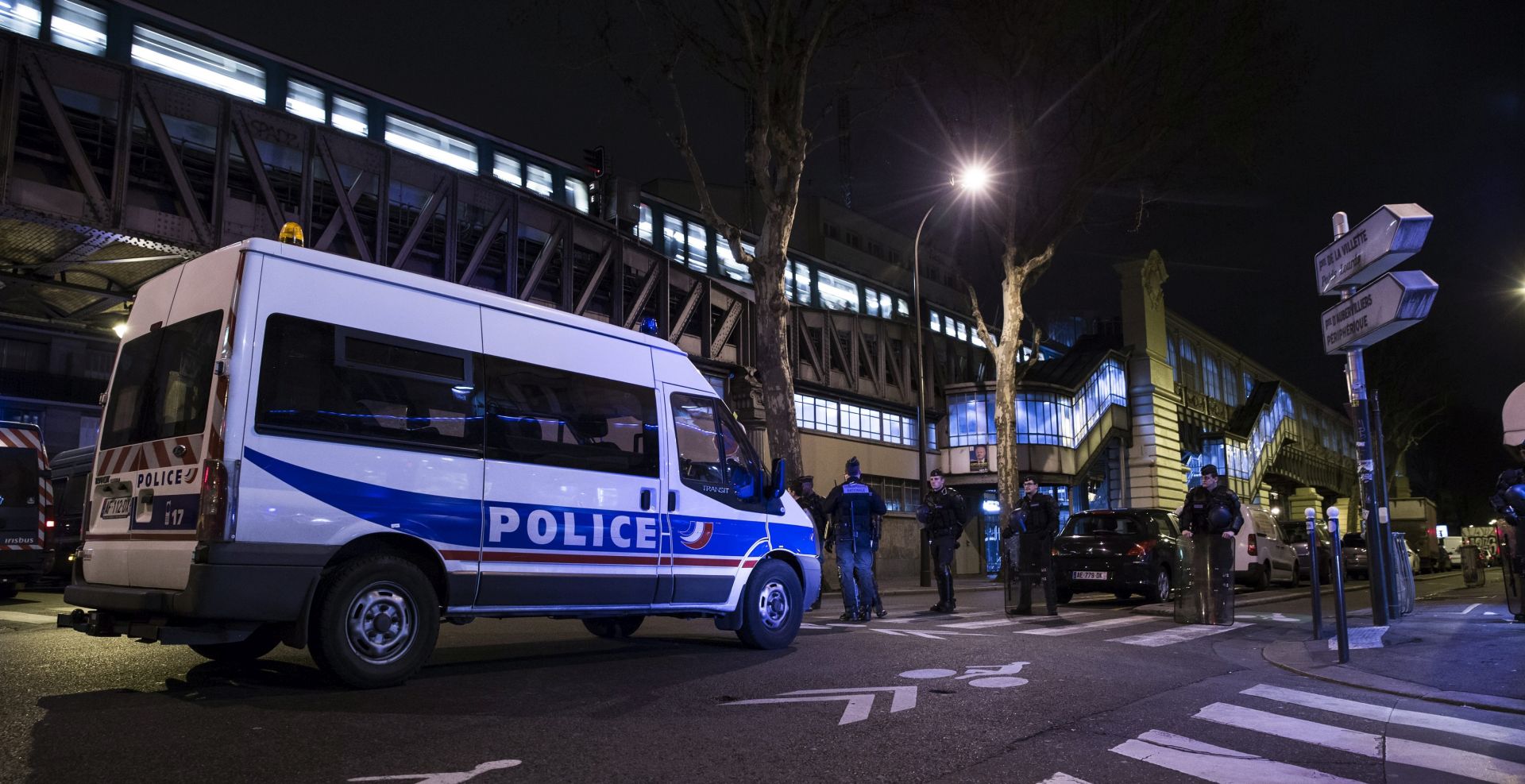 epa05235803 French police stand guard as the makeshift migrant camp set up under the elevated metro station of Stalingrad is being emptied, in Paris, France, 30 March 2016. Most of the migrants tried their luck in Calais to access England but failed and chose to come to Paris and ask for papers and a recognition of the refugee status.  EPA/ETIENNE LAURENT