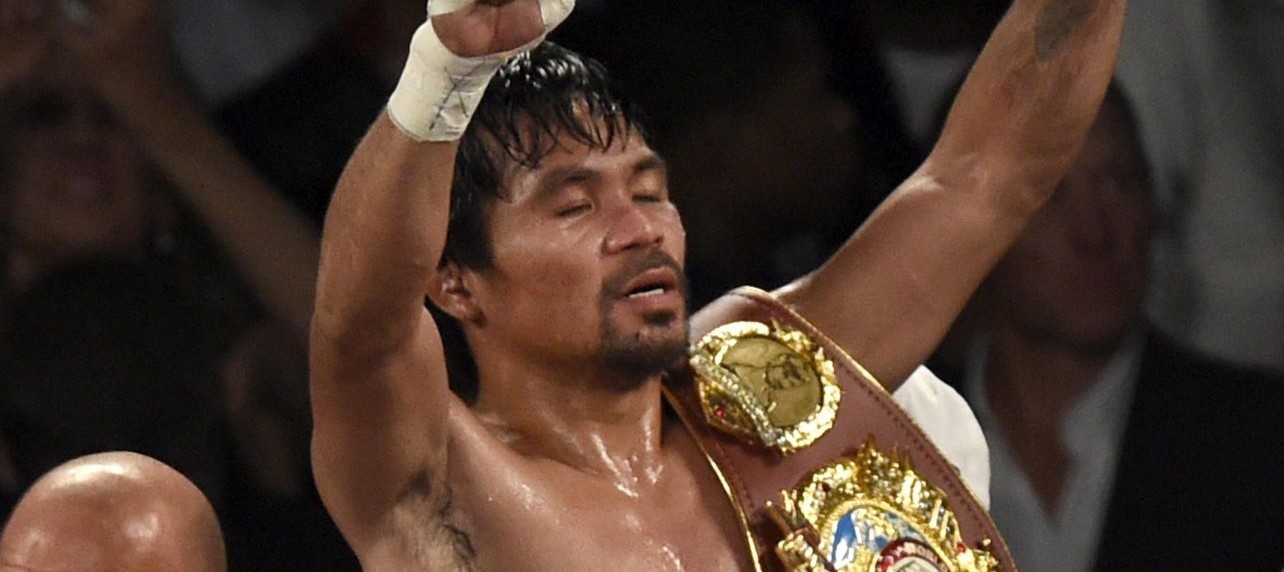 epa05252130 Manny Pacquiao of the Philippines celebrates after defeating Timothy Bradley of the USA in their WBO International Welterweight Championship title at the MGM Grand Garden Arena in Las Vegas, Nevada, USA, 09 April 2016.  EPA/JOHN G. MABANGLO