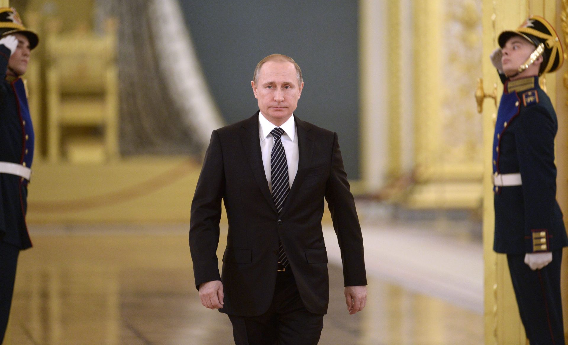epa05215980 Russian President Vladimir Putin (C) enters the St.Alexander Hall to attend a ceremony of presentation of the Aerospace Forces banner in the Kremlin in Moscow, Russia, 17 March 2016. Putin highly appreciated the activities of the Russian Air Force in Syria.  EPA/ALEXEY NIKOLSKY / SPUTNIK / KREMLIN POOL MANDATORY CREDIT