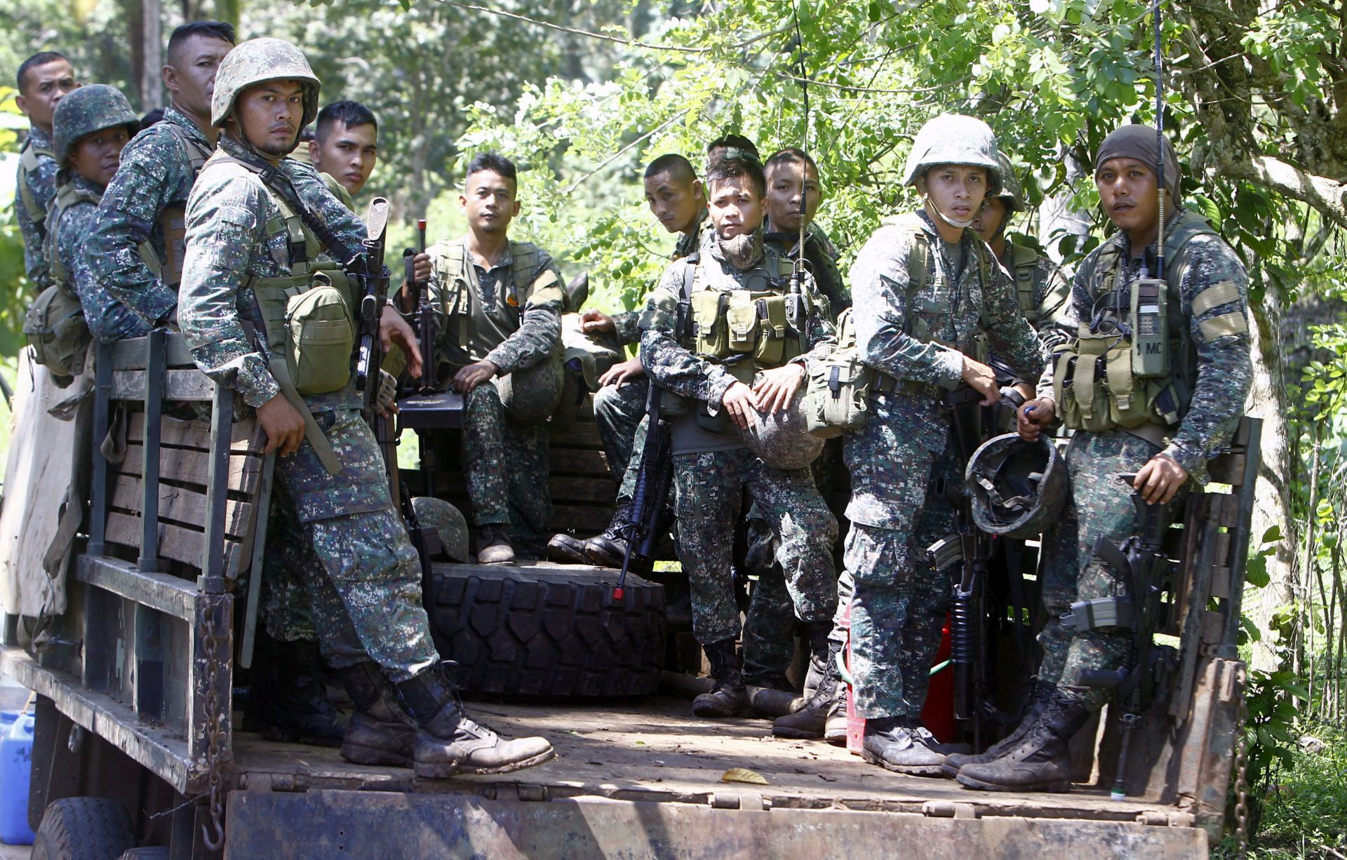 epa05279154 Filipino soldiers are seen in the back of a military truck as they wait for orders during a military offensive on the outskirts of Jolo, Sulu Island, southern Philippines, 27 April 2016. The Armed Forces of the Philippines (AFP) and the Philippine National Police (PNP) vowed to 'neutralize' Abu Sayyaf terrorists after the beheading of a Canadian hostage, who was kidnapped from a resort in the southern Philippines along with three others in September. 'There will be no let-up in the determined efforts of the joint AFP- PNP task group's intensive military and law enforcement operations to neutralize these lawless elements and thwart further threats to peace and security,' said the army and the police in a statement issued. 'The President has directed the security forces to apply the full force of the law to bring these criminals to justice,' read the statement, in which authorities also conveyed condolences to the Canadian government and the family of the victim John Ridsdel.  EPA/BEN HAJAN