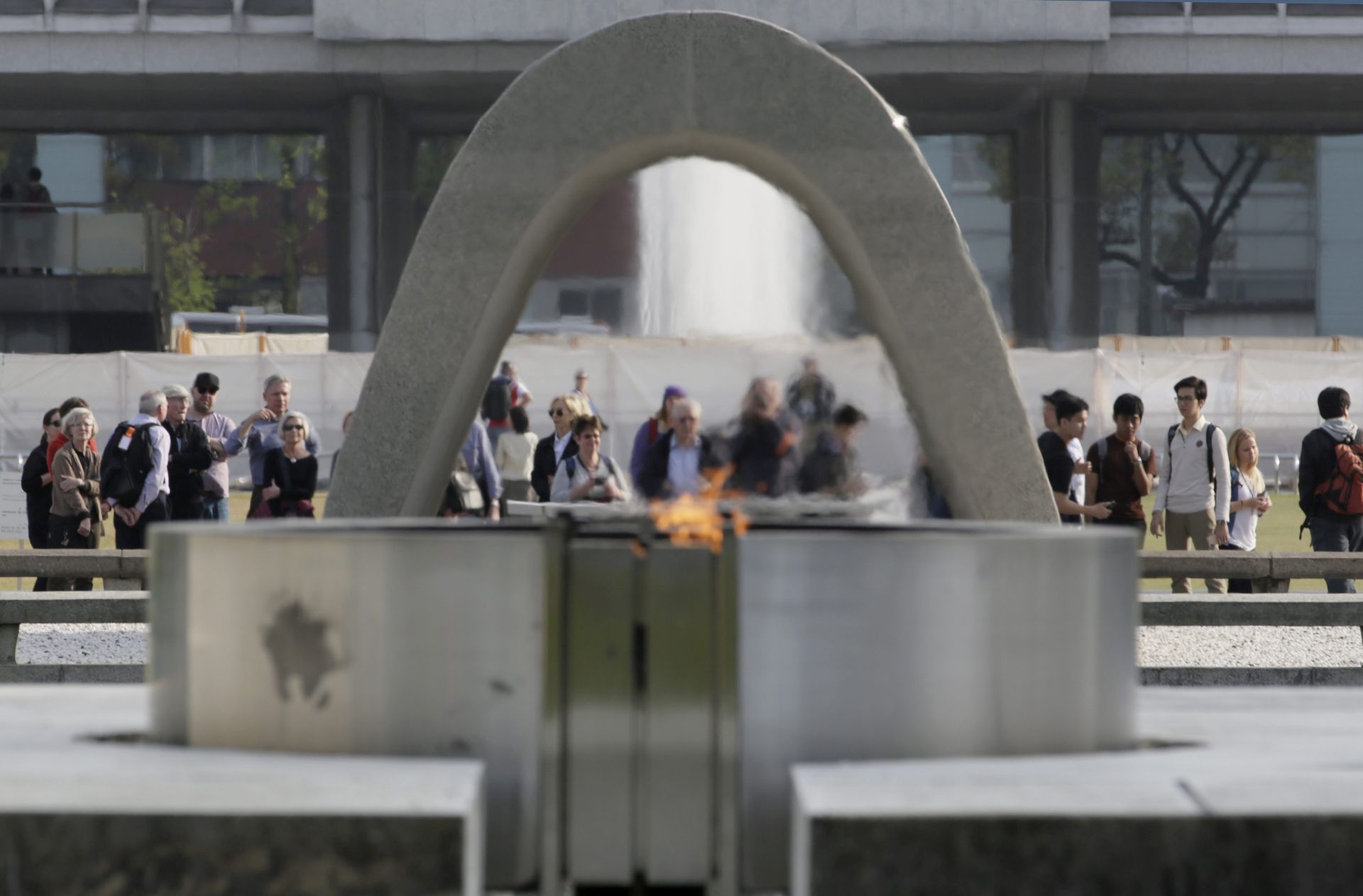 epa05250715 Visitors make a moment in front of a cenotaph with the Eternal Flame of Peace at Hiroshima Peace Memorial Park viewing in Hiroshima, Hiroshima Prefecture, western Japan, 09 April 2016, on the eve of the Group of Seven (G-7) foreign ministerial meeting. The Group of Seven countries' foreign ministers will gather on 10 April 2016 for two-day talks. The ministers from Britain, Canada, France, Germany, Italy, Japan and the United States will meet to talk about various themes including nuclear disarmament and non-proliferation in the atomic bombing city of Hiroshima and visit the Peace Memorial Park to offer a wreath to a cenotaph and pray.  EPA/KIMIMASA MAYAMA