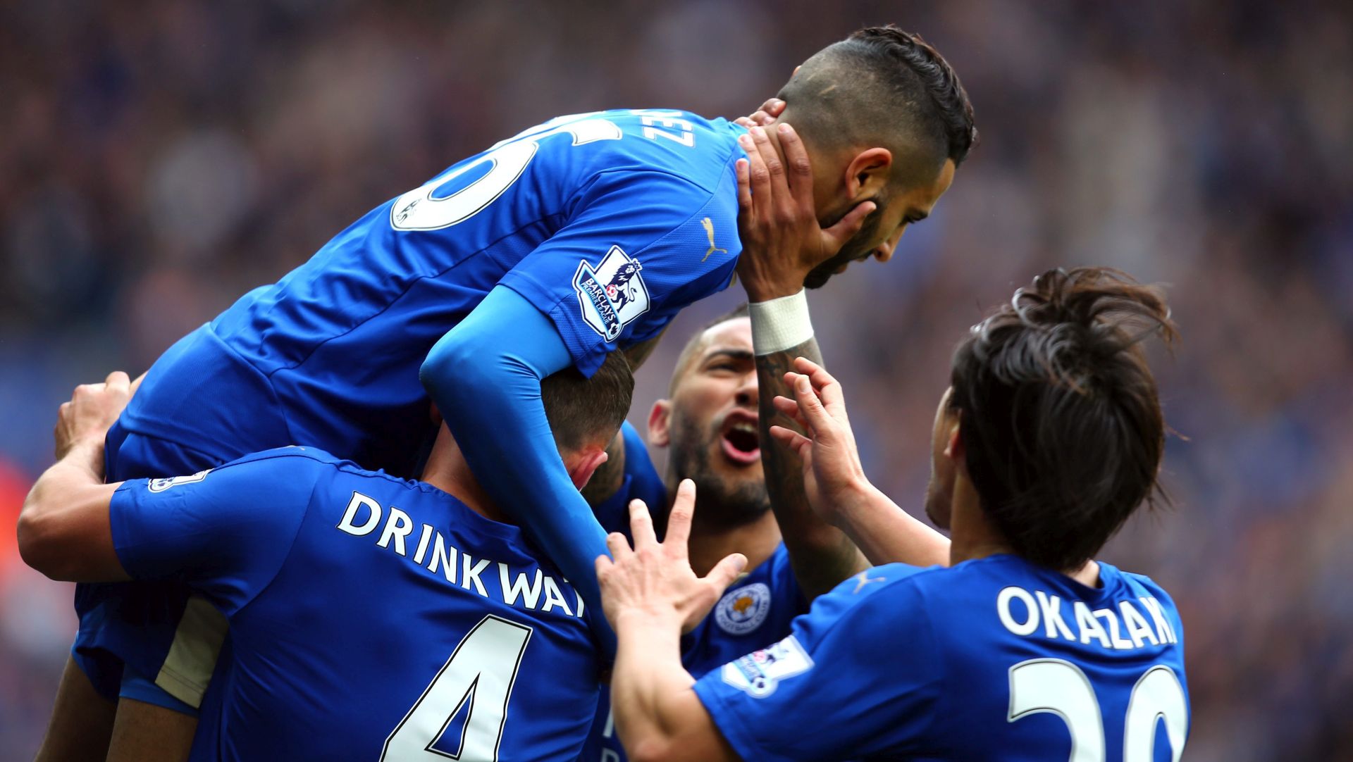 epa05275523 Leicester City's Riyad Mahrez (top) celebrates his opening goal with team mates during the English Premier League soccer match between Leicester City and Swansea City at The King Power Stadium in Leicester, Britain, 24 April 2016.  EPA/TIM KEETON EDITORIAL USE ONLY. No use with unauthorized audio, video, data, fixture lists, club/league logos or 'live' services. Online in-match use limited to 75 images, no video emulation. No use in betting, games or single club/league/player publications.