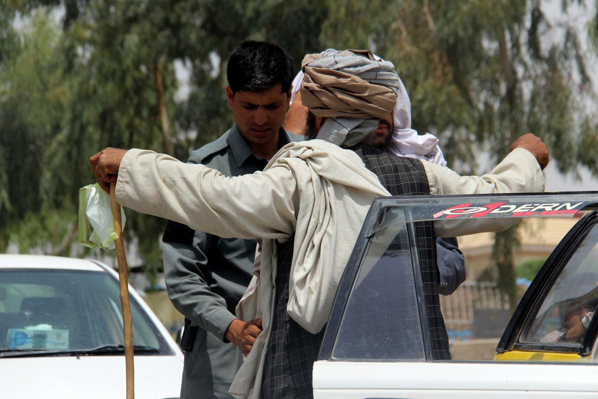 epa05286803 An Afghan security official frisks a man on a roadside in Kandahar, Afghanistan 02 May 2016. Security has been intensified after 45 Taliban were killed including a shadow governor of Taliban for the southern Kandahar province and his deputy in clashes for the control of Kandahar-Uruzgan highway, according to media reports.  EPA/MUHAMMAD SADIQ