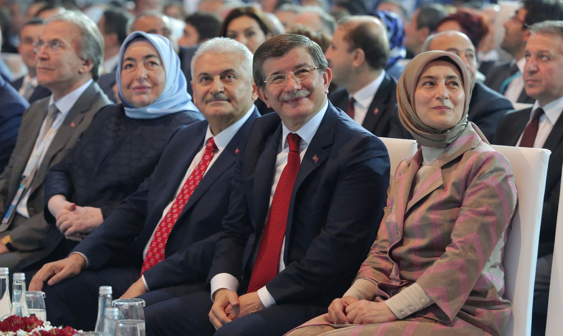 epa05322984 Turkey's Transportation Minister Binali Yildirim (3-R) and his wife Semiha (2-L), Turkey's Prime Minister Ahmet Davutoglu (2-R) and his wife Sare (R) attend the Extraordinary Congress of the ruling Justice and Development Party (AKP) to choose the new leader of the party in Ankara, Turkey, 22 May 2016. Binali Yildirim was named on 19 May as the sole candidate to head Turkey's ruling Justice and Development, or AKP, party to succeed Ahmet Davutoglu, who resigned as prime minister.  EPA/RIZA OZEL / POOL