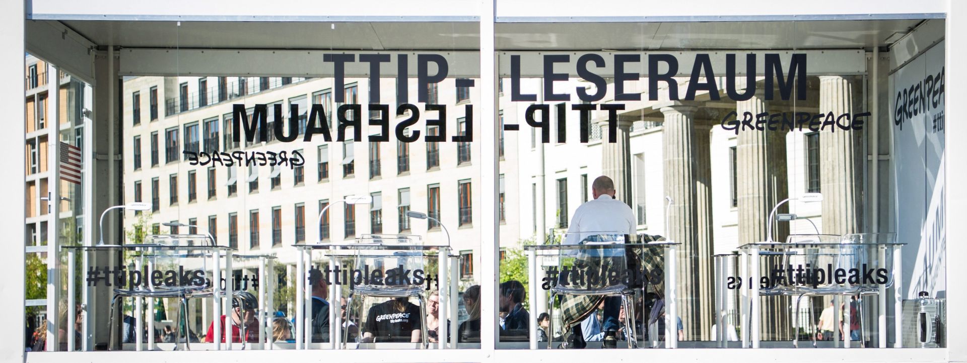 epa05287107 A man sitting in a see-through reading room near the Brandenburg Gate reads the leaked TTIP documents published by Greenpeace, in Berlin, Germany, 02 May 2016. The environment protection organization Greenpeace released confidential documents on 02 May on the negotiations for the Transatlantic Trade and Investment Partnership (TTIP), a proposed trade agreement between the European Union (EU) and the US.  EPA/SOPHIA KEMBOWSKI