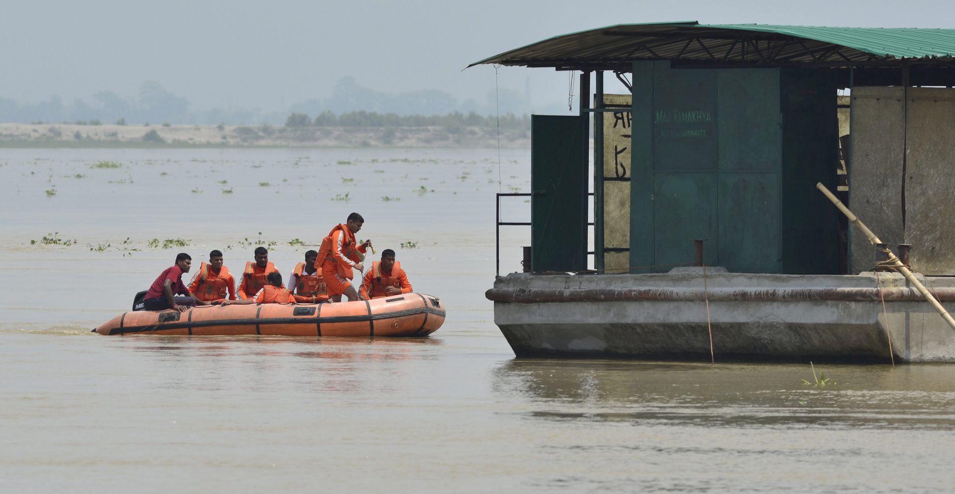 epa05278140 Indian National Digester Response Force (NDRF) personnel patrol in the Brahmaputra river following the increase of flood water level in Guwahati city, Assam, India, 26 April 2016. Around 100,000 people have been affected in Assam state caused by intense rainfall in upper Assam since last two weeks.  EPA/STR