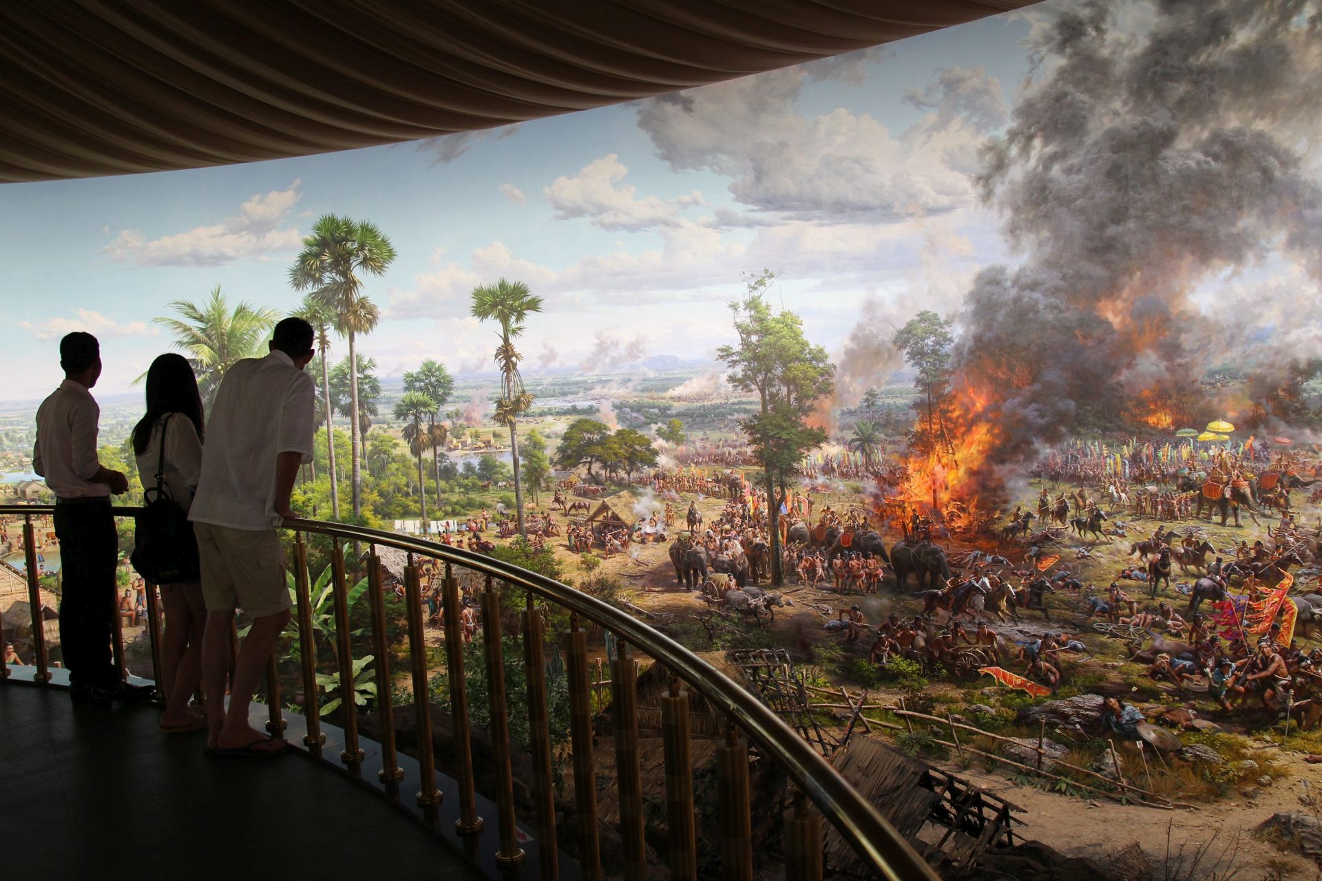 epaselect epa05324669 Tourists view a painting on the wall of the Angkor Panorama Museum in Siem Reap, Cambodia, 23 May 2016. The Museum was built with funds provided by the North Korean government  and took almost two years to complete. The museum features a 360-degree mural painted by 63 North Korean artists and also displays models of all the main temples in Siem Reap province.  EPA/MAK REMISSA