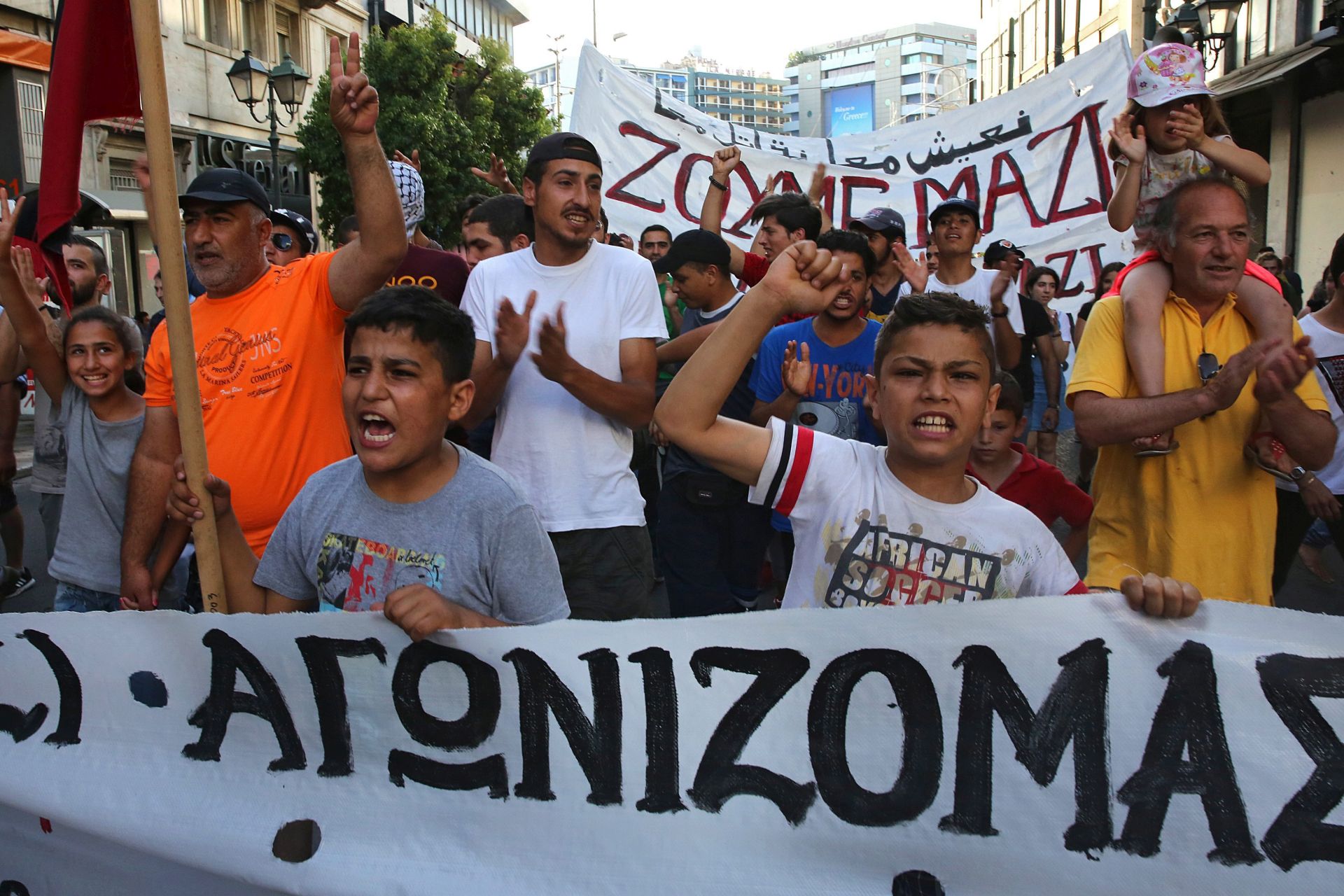 epa05370371 Refugees who have found shelter in squatted buildings organised by the antiautoritarian movement of Greece, rally in the centre of Athens demanding the opening of the border and the stop of the deportations to Turkey, in Athens, Greece, 16 June 2016. Some 1200 refugees from Syria, Iraq and Afghanistan live in the squatts of Athens.  EPA/ORESTIS PANAGIOTOU
