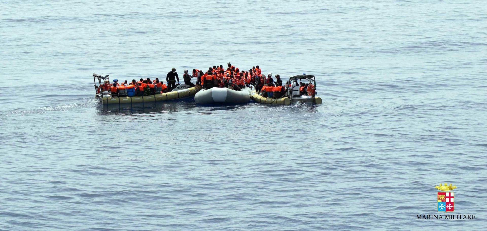 epa05337346 An undated handout picture provided by the Italian Navy Marina Militare on 30 May 2016 shows migrants being rescued at sea. Rescue operations are continuing in the Mediterranean Sea after more than 12,000 people were saved last week, when three ships capsized over three consecutive days, killing at least 65 people.  EPA/US MARINA MILITARE/HANDOUT  HANDOUT EDITORIAL USE ONLY/NO SALES