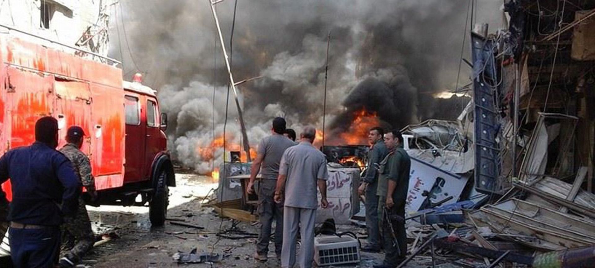 epa05356700 A handout photograph made available by the official Syrian Arab News Agency (SANA) shows rescuers and firefighters working at the site of bombing in Assayidah Zainab neighborhood, Damascus, Syria, 11 June 2016. According to SANA, eight people were killed and dozen others injured in two blasts targeting Assayidah Zainab neighborhood in Damascus.  EPA/SANA HANDOUT  HANDOUT EDITORIAL USE ONLY/NO SALES