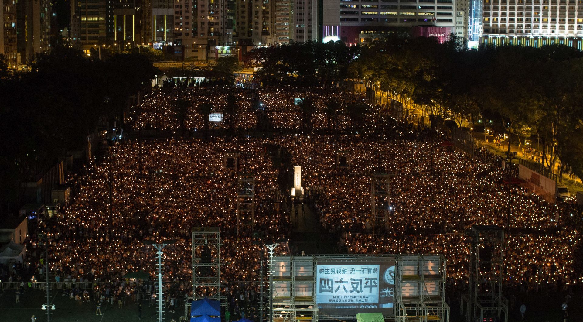epa05345498 Participants hold candles during the 27th anniversary of the Tiananmen Square crackdown in Victoria Park, Hong Kong, China, 04 June 2016. Thousands of Hong Kongers took part in a candlelight vigil at Victoria Park to remember those who died in China's Tiananmen crackdown in 1989. In the early hours of 04 June 1989, Chinese troops cracked down on student protesters at Tiananmen Square in Beijing, leaving many students killed or injured.  EPA/JEROME FAVRE