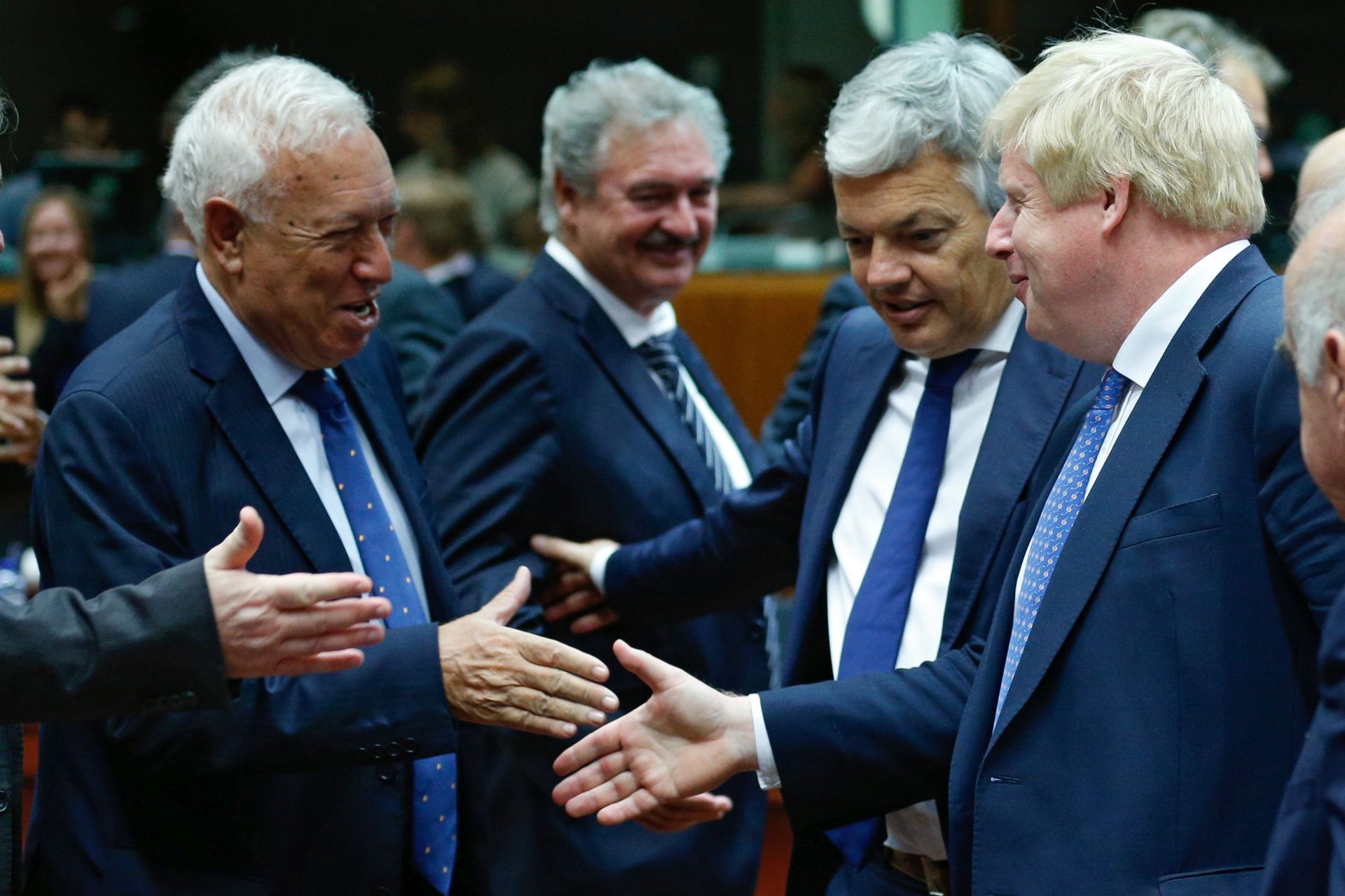 epa05430169 Spanish Foreign Minister Jose Manuel Garcia-Margallo (L-R), Belgium's Foreign Minister Didier Reynders, and Britain's Foreign Secretary Boris Johnson shake hands during an EU Foreign Affairs Council meeting in Brussels, Belgium 18 July 2016. The meeting's agenda is expected to be topped by talks on Turkey, Syria, and the Middle East.  EPA/LAURENT DUBRULE