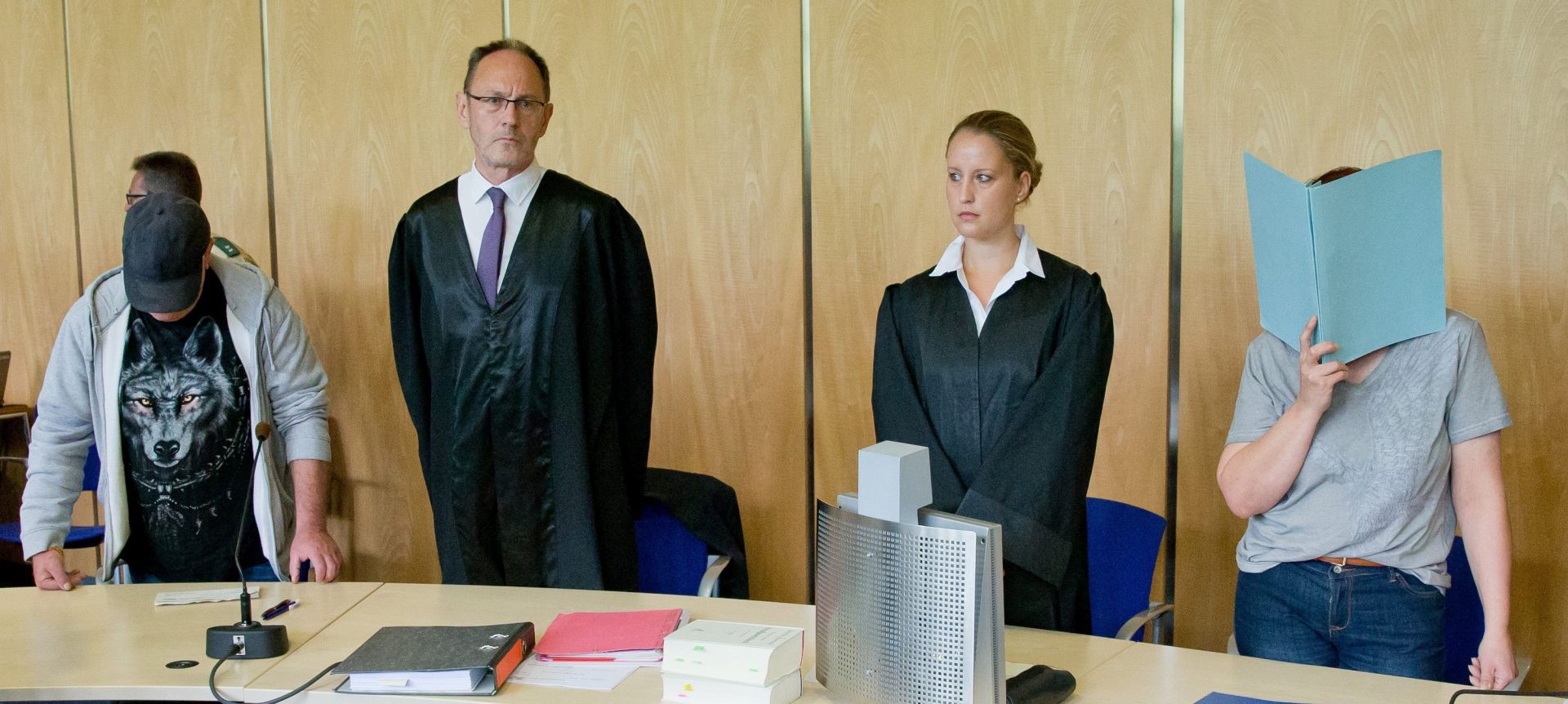epa05421385 Defendant Andrea G. (R), who is accused of murder, covers her face with a folder as she sits next to her lawyers Julia Gremmelmaier (2-R) Till Wagler (2-L) and her Husband Johann G. (L) who is acccused of being her accomplice, in the court room of the regional court in Coburg, Germany, 12 July 2016. After 8 of her children's were found dead at her house, the prosecution has accused Andrea G. of deliberately killing 4 of them. Their father is accused of assisting his wife.  EPA/DANIEL KARMANN