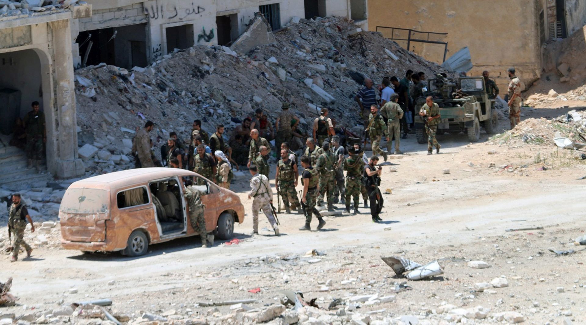 epa05445567 A handout photo released by the official Syrian Arab News Agency (SANA) on 28 July 2016 shows Syrian government soldiers patrolling in al-Layramoun and Bani Zein neighborhoods after recapturing from rebels in the northern province of Aleppo, Syria. According to SANA, Syrian army unites recaptured Bani Zaid neighborhood and began an operation to dismantle the explosives and mines left by opposition forces.  EPA/SANA HANDOUT  HANDOUT EDITORIAL USE ONLY/NO SALES